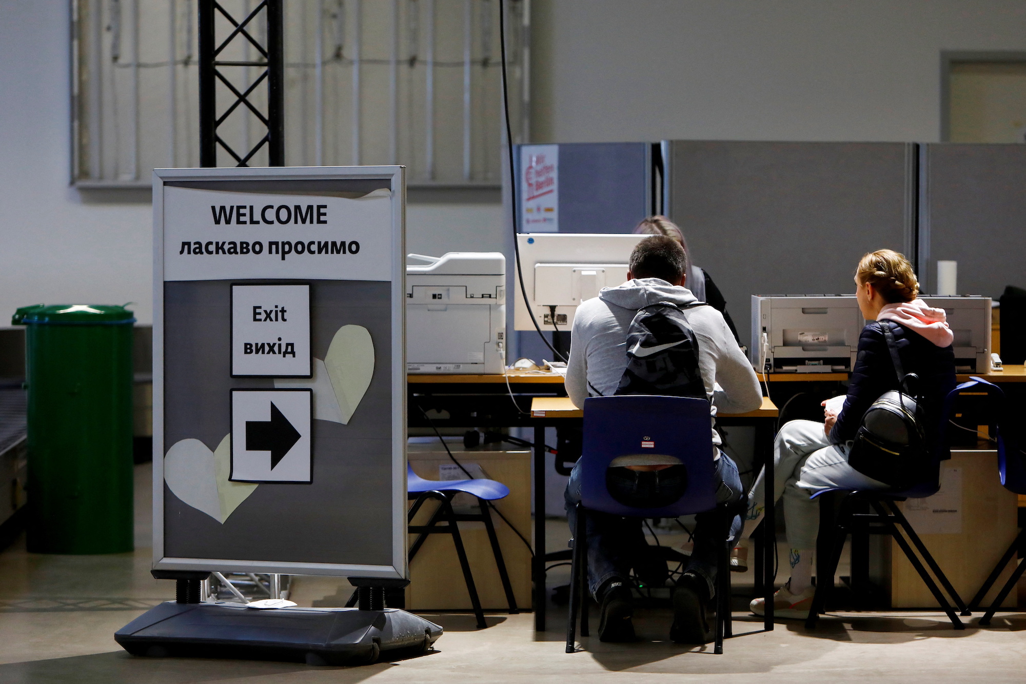 People sit at the registration as they arrive at the accommodation center for refugees from Ukraine in Berlin on May 17.