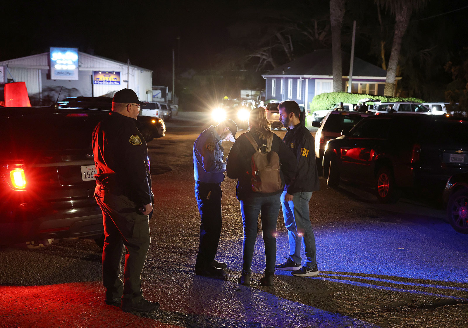 A San Mateo County deputy sheriff checks on FBI agents as they arrive at the scene of a shooting on January 23 in Half Moon Bay, California. 
