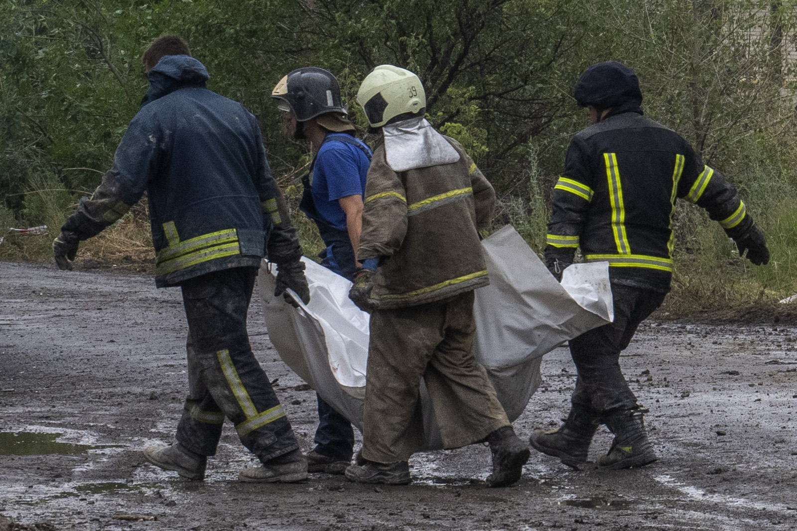 Ukrainian emergency workers carry the lifeless body of a victim found under rubble in Chasiv Yar, Donetsk region, eastern Ukraine, on July 11.
