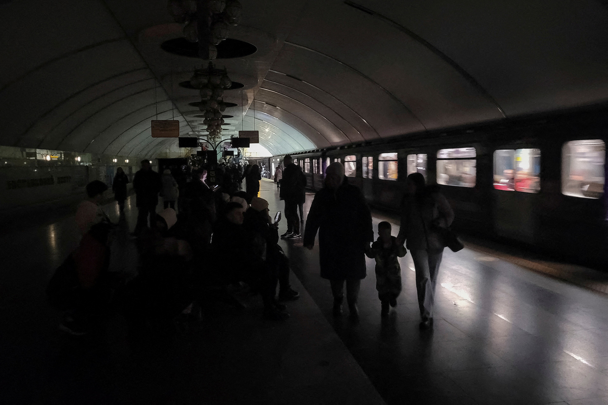People shelter inside a metro station during a partial power outage amid massive Russian missile attacks in Kyiv, on December 16.