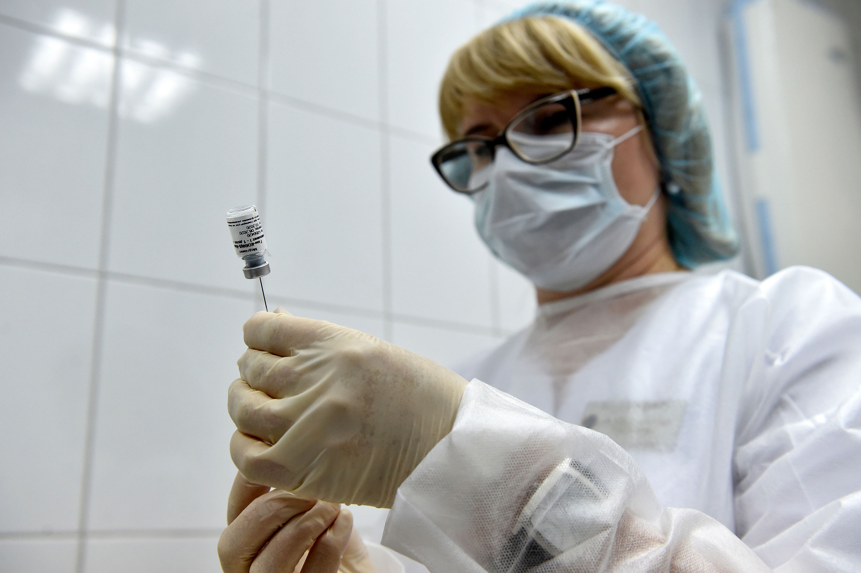A nurse prepares to inoculate a volunteer with Russia's new coronavirus vaccine in post-registration trials at a Moscow clinic on September 10.