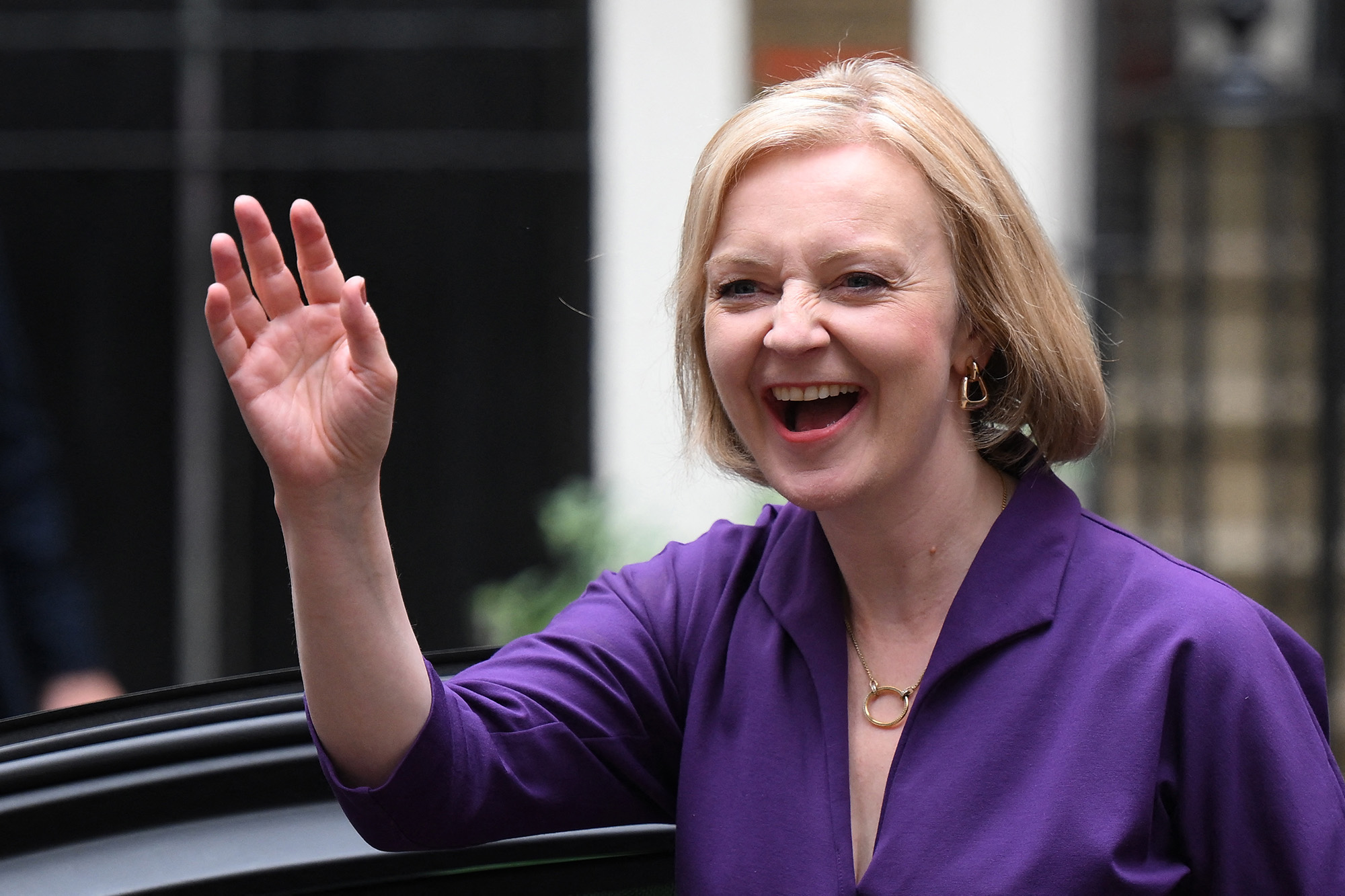 New Conservative Party leader and incoming prime minister Liz Truss smiles and waves as she arrives at Conservative Party Headquarters in central London having been announced the winner of the Conservative Party leadership contest at an event in central London, on September 5.