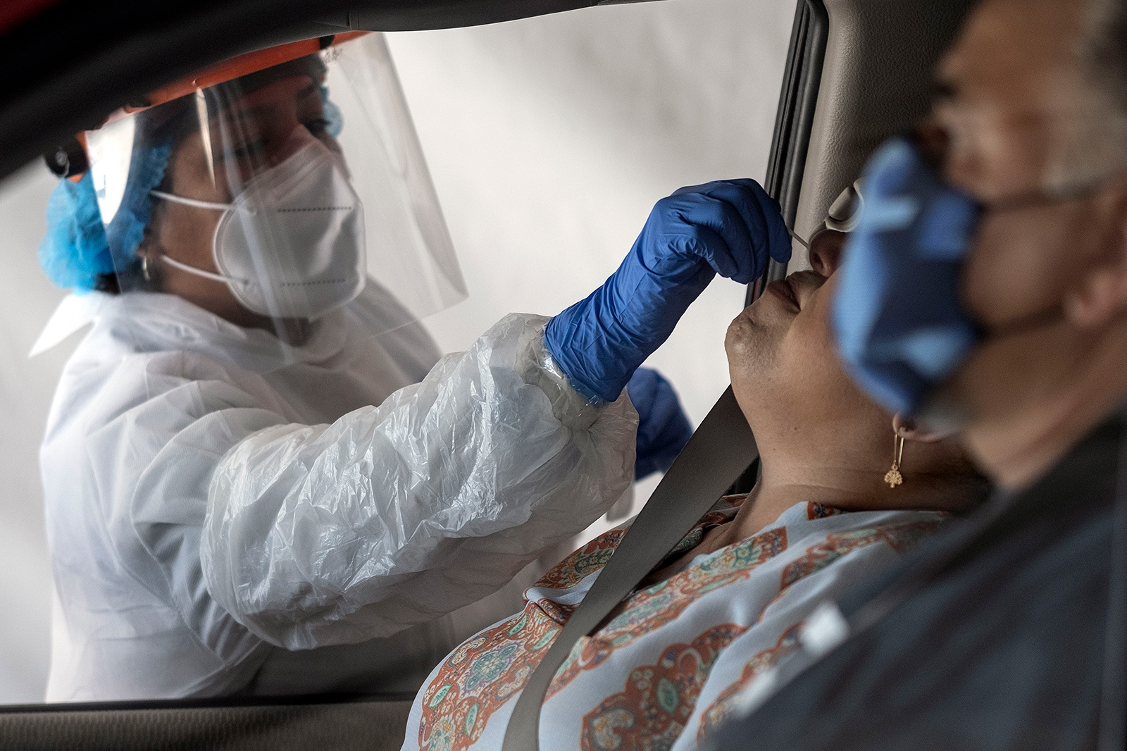 A laboratory worker takes a sample of a person at a Covid-19 drive-thru test center in Tijuana, Baja California State, Mexico, on July 21.