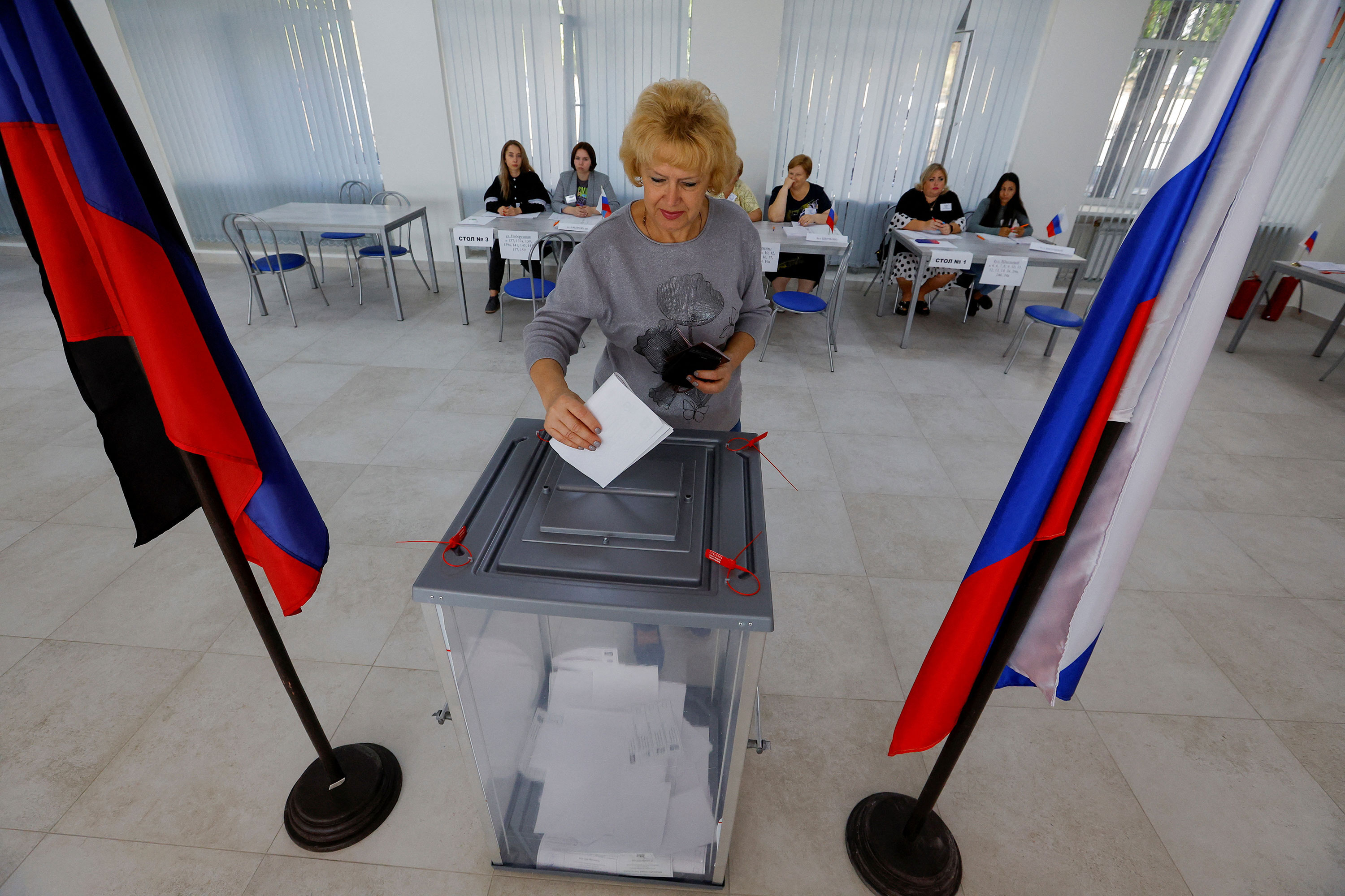 A voter casts a ballot at a polling station during local elections held by Russian-installed authorities in Donetsk, Russian-controlled Ukraine, on September 8.