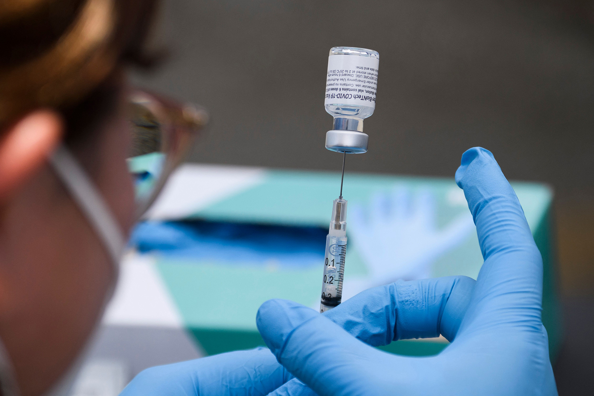 A syringe is filled with a first dose of the Pfizer Covid-19 vaccine at a mobile vaccination clinic during a back to school event offering school supplies, Covid-19 vaccinations, face masks, and other resources for children and their families at the Weingart East Los Angeles YMCA in Los Angeles, California on August 7, 2021. 