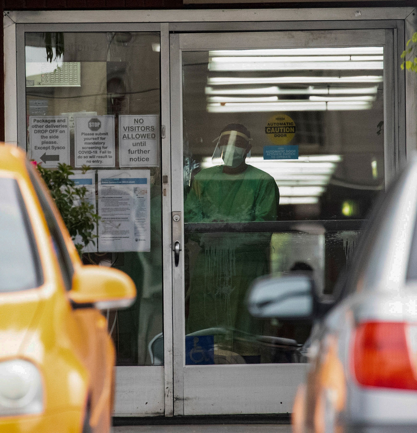 A person in protective gear stands inside the Brier Oak on Sunset nursing home in Los Angeles on April 18. 