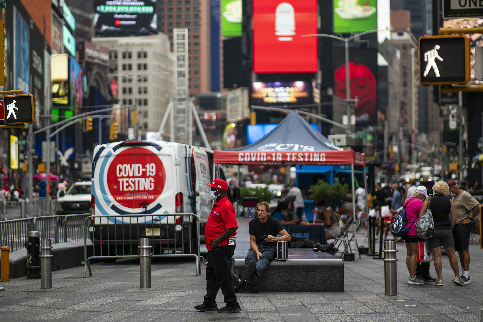 People walk by a COVID 19 testing center on Times Square on August 30, 2021 in New York City. 