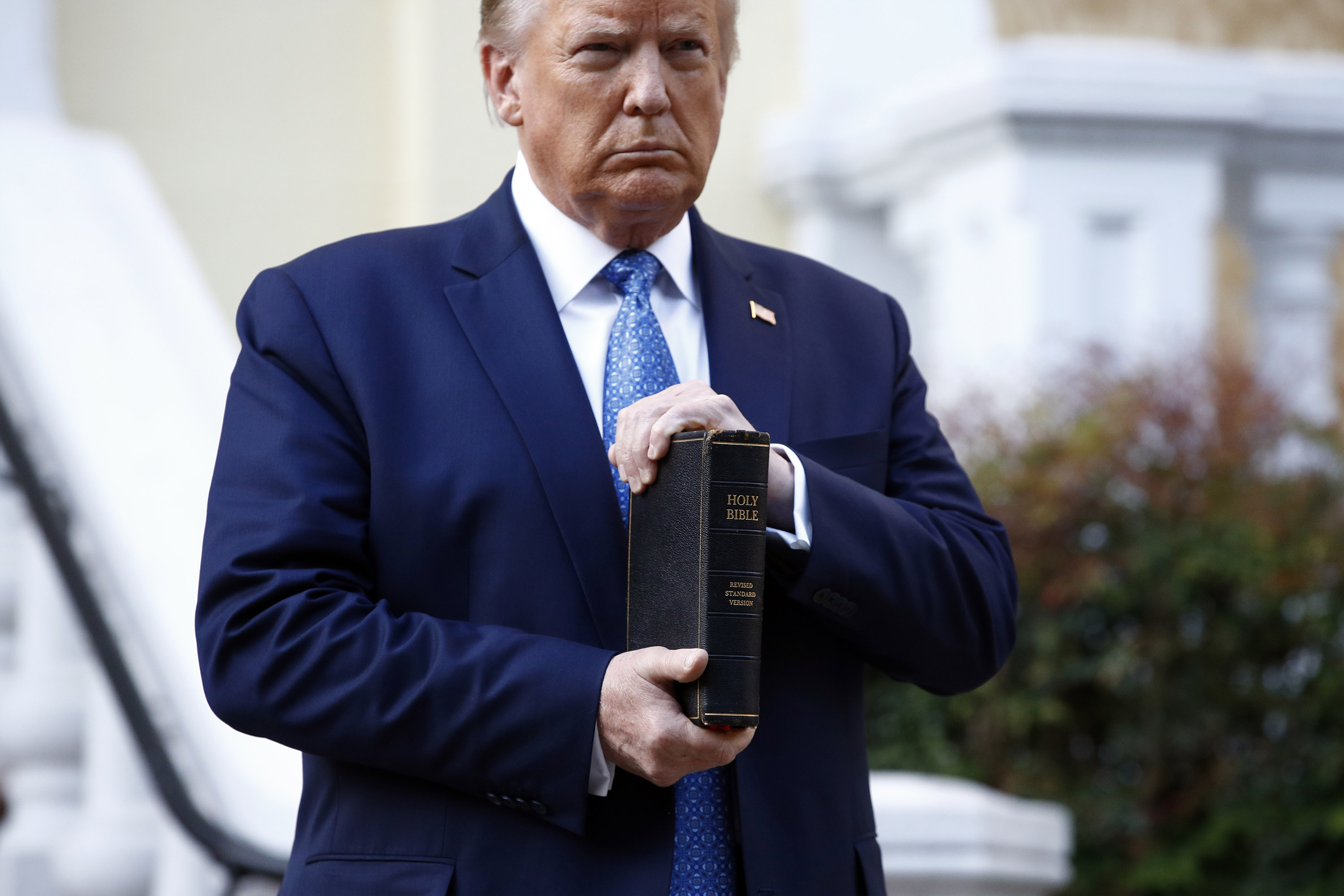 President Donald Trump holds a Bible as he visits outside St. John's Church across Lafayette Park from the White House Monday, June 1, 2020, in Washington. 