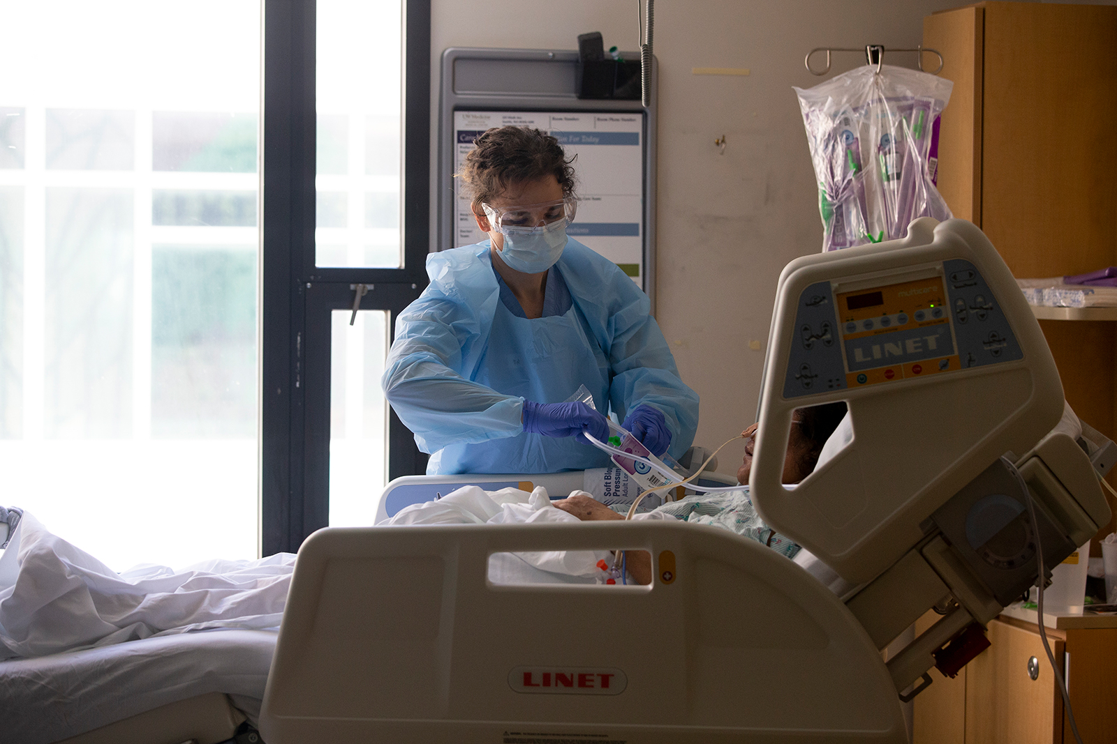 Nurse Karen Hayes administers care to a patient in the acute care Covid-19 unit at Harborview Medical Center on May 7, in Seattle, Washington.