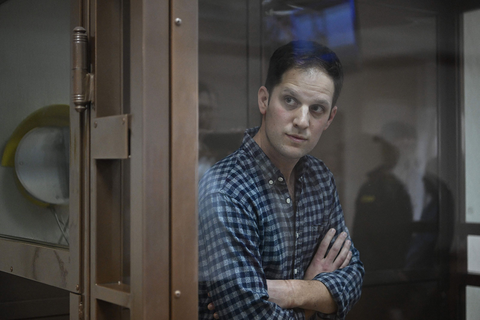 Evan Gershkovich stands inside a defendants' cage before a hearing in Moscow on April 18, 2023. 