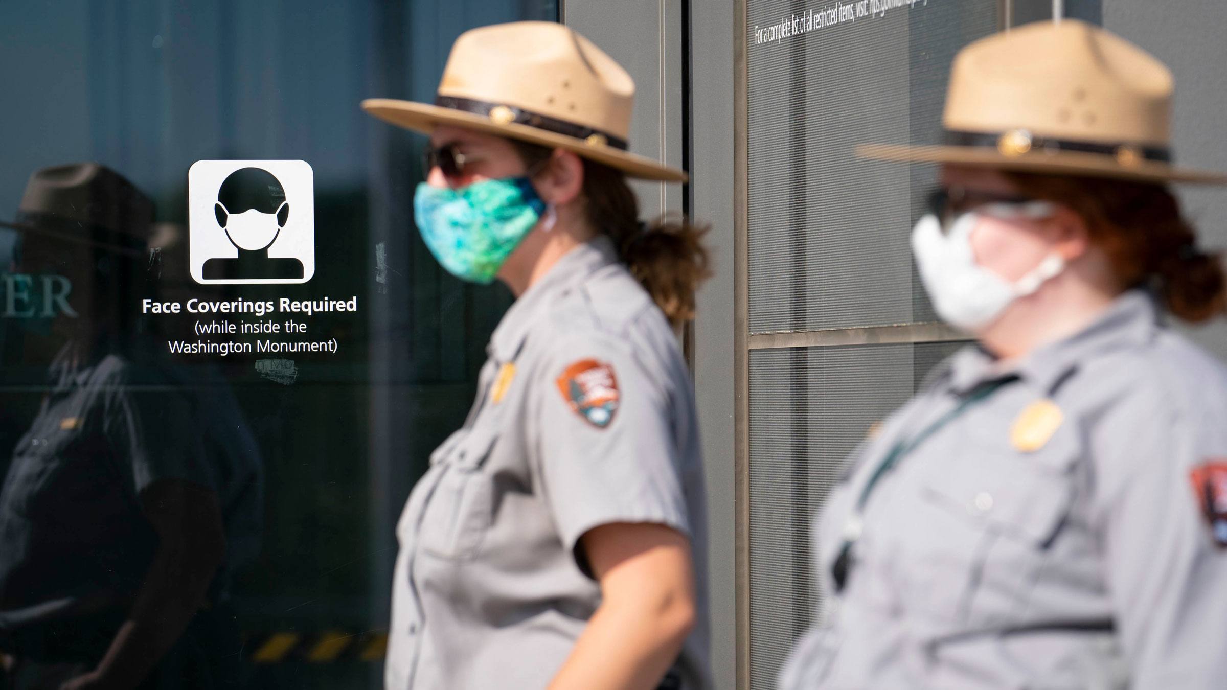 National Park Service rangers wear face masks as they interact with visitors at the reopening of the Washington Monument in October 2020.