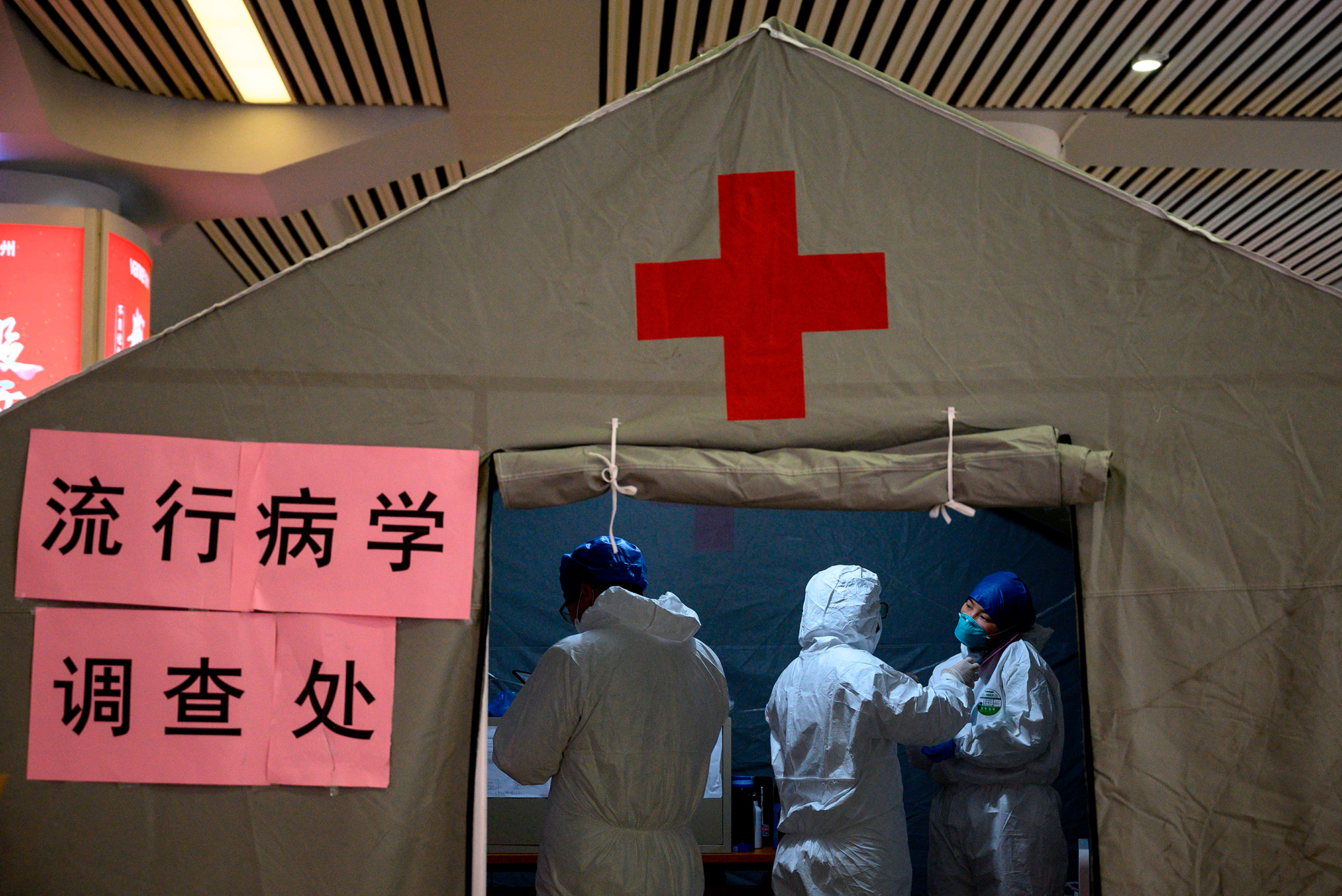 Health personnel work at their medical tent erected at the Hangzhou East Railway station in Hangzhou on February 5.