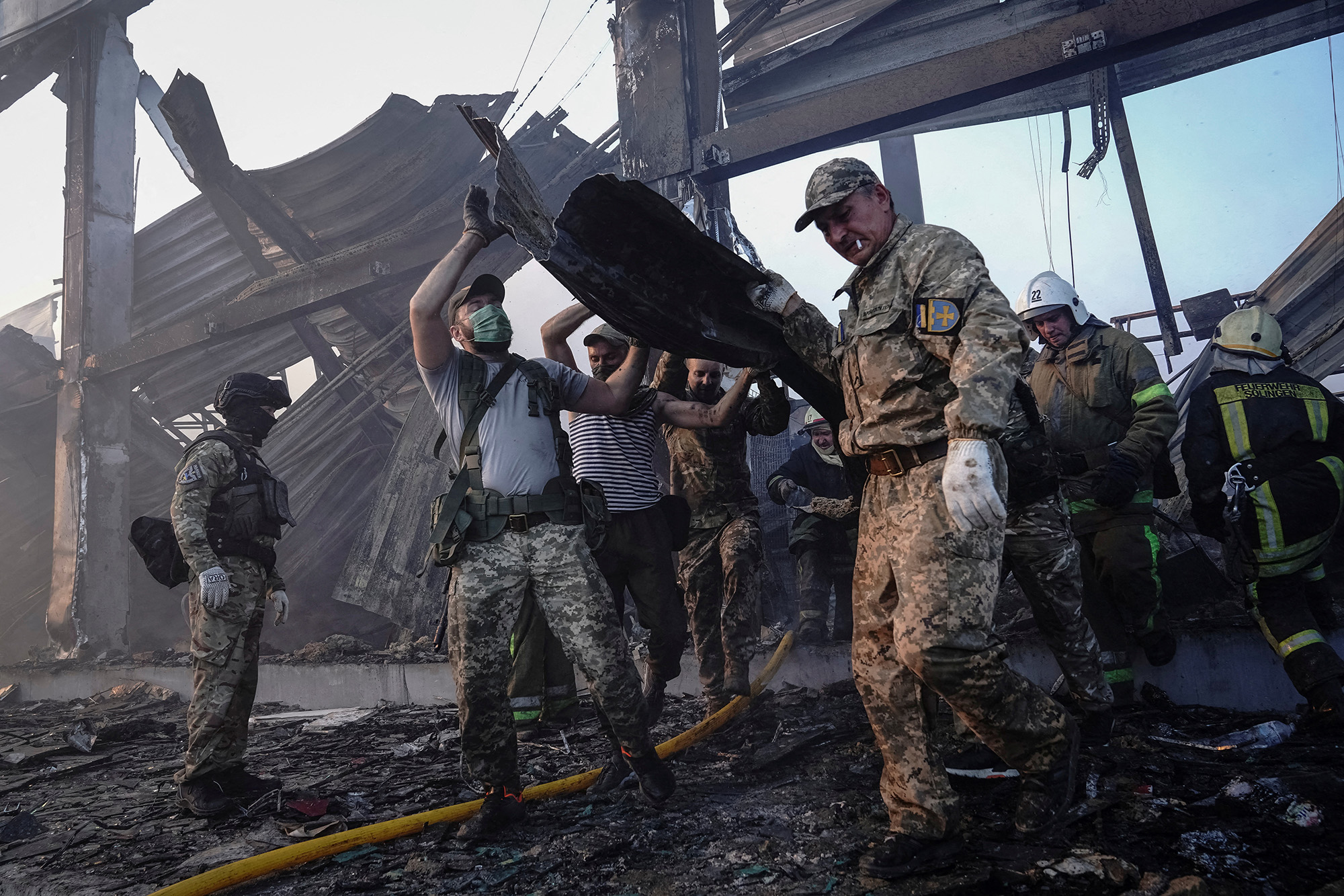 Rescuers work at a site of a shopping mall hit by a Russian missile strike in Kremenchuk, Ukraine, on June 27.