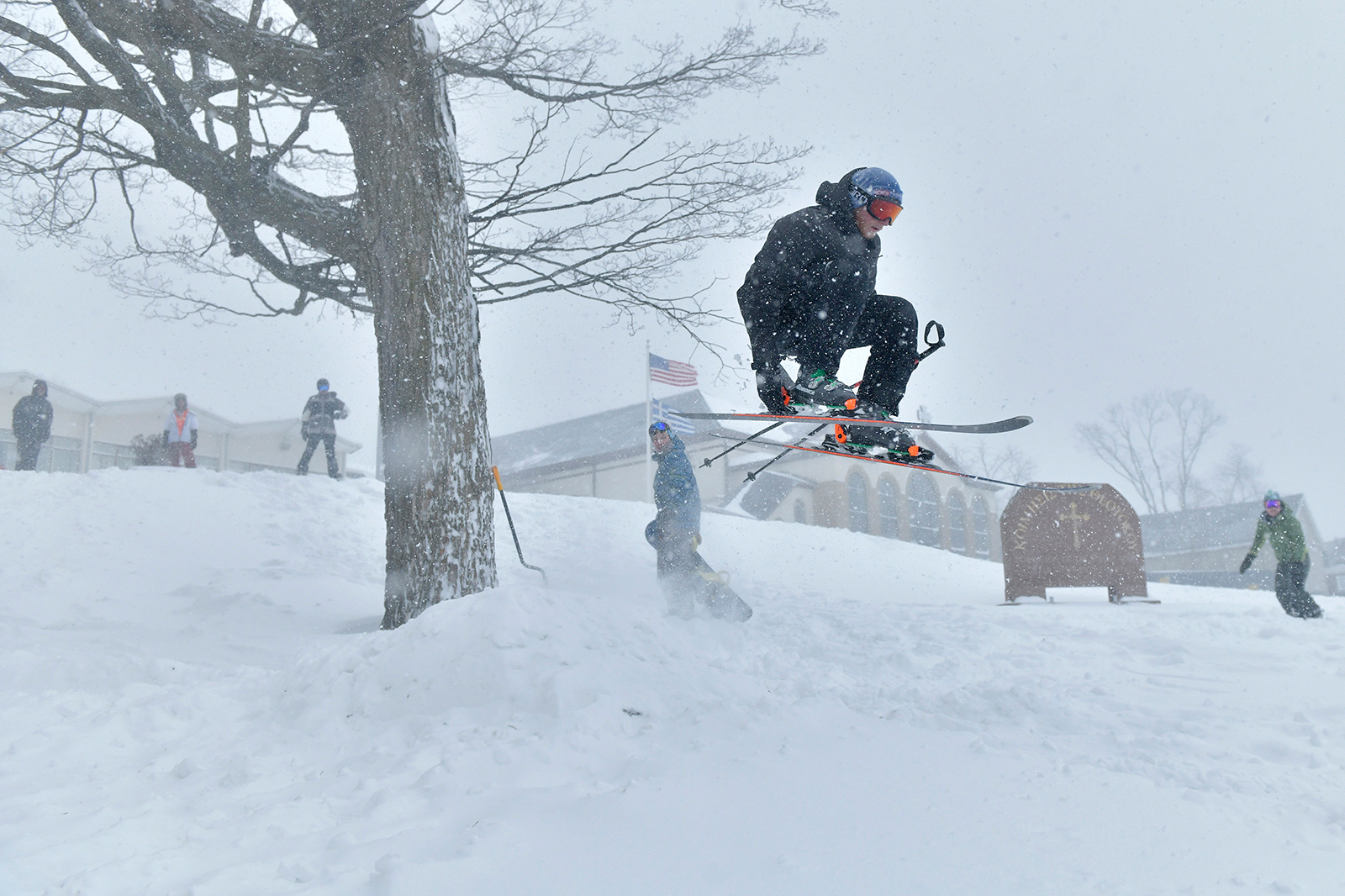 Zack Andersen skis off a jump built on the lawn of Dormition of the Virgin Mary Greek Orthodox Church, on Saturday, January 29, in Somervillle, Mass. 