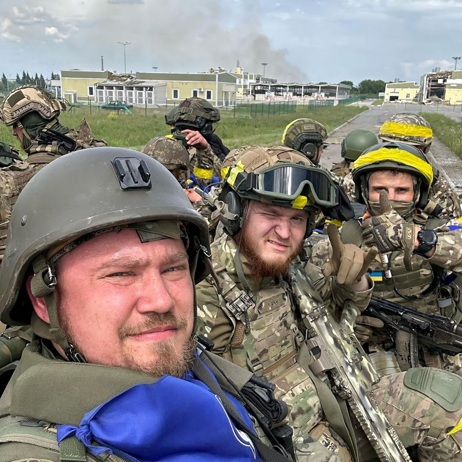 Members of the Russian Volunteer Corps pose atop an armoured vehicle in Kozinka, Belgorod, in this photo released on May 23. 