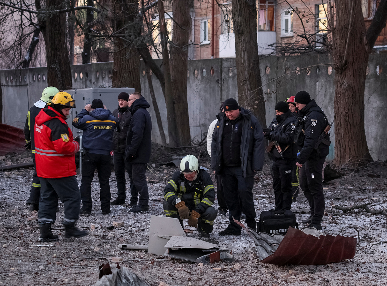 Rescuers and police officers examine parts of the drone at the site of a building destroyed by a Russian drone attack in Kyiv on Wednesday.