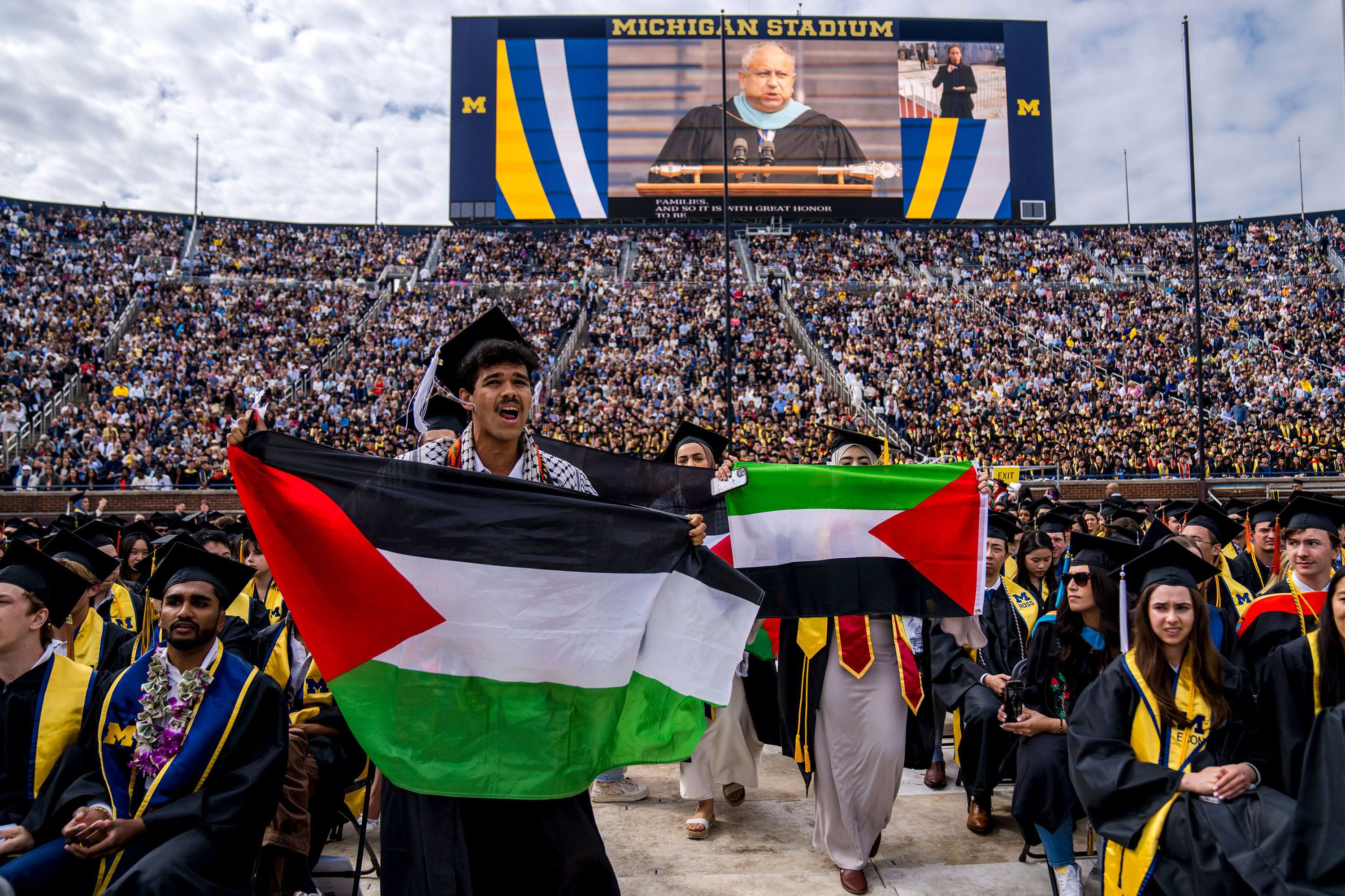 Protesters carry Palestinian flags during the University of Michigan's main commencement in Ann Arbor, Michigan, on Saturday. 