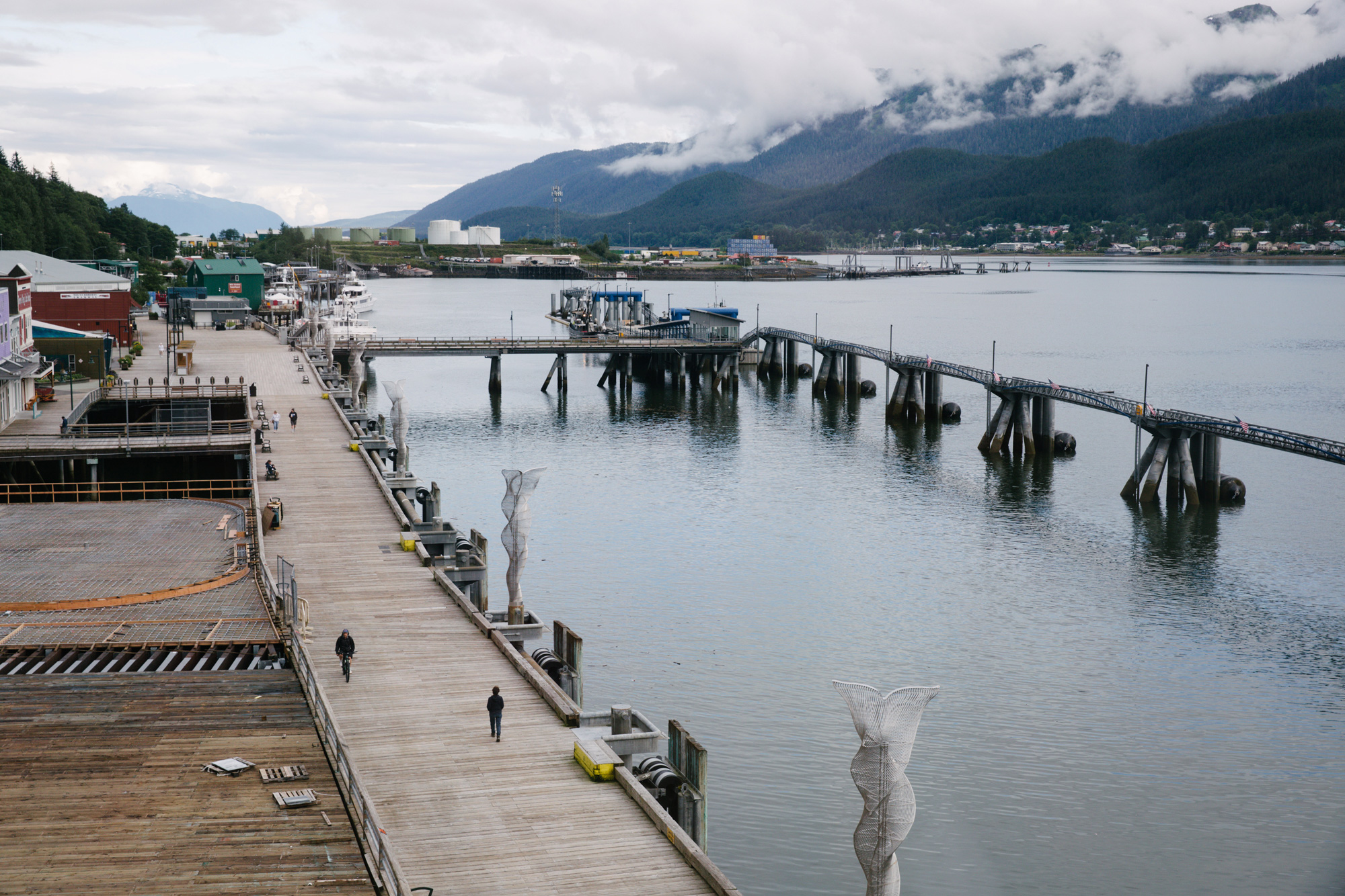 Pedestrians walk through an empty cruise ship port in Juneau, Alaska, on July 24.