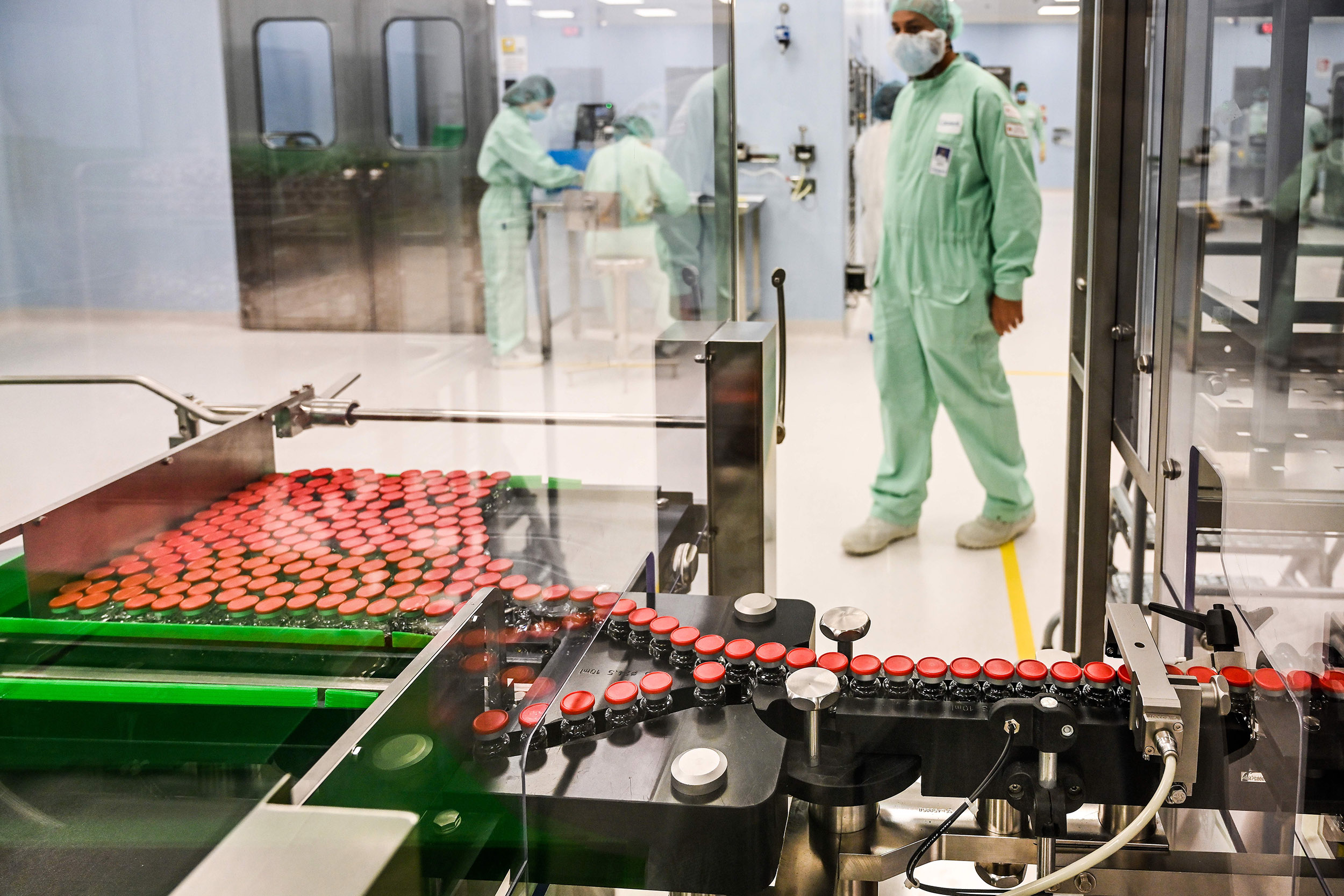 A laboratory technician supervises capped vials during filling and packaging tests for the large-scale production and supply of the University of Oxfords COVID-19 vaccine candidate, AZD1222, conducted on a high-performance aseptic vial filling line on September 11, 2020 at the Italian biologics manufacturing facility of multinational corporation Catalent in Anagni, Italy. 