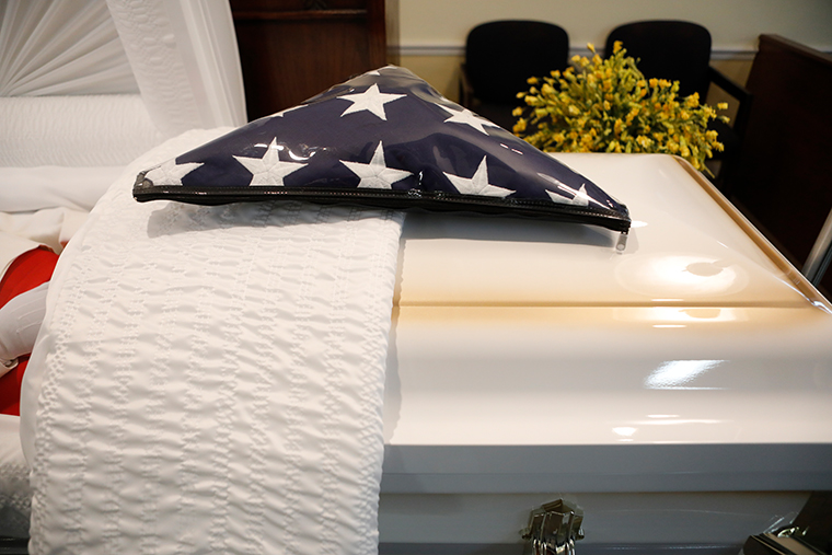 An American flag sits on top of a casket for a veteran who died of COVID-19 before his funeral at Ray Williams Funeral Home on August 12, 2020 in Tampa, Florida. 