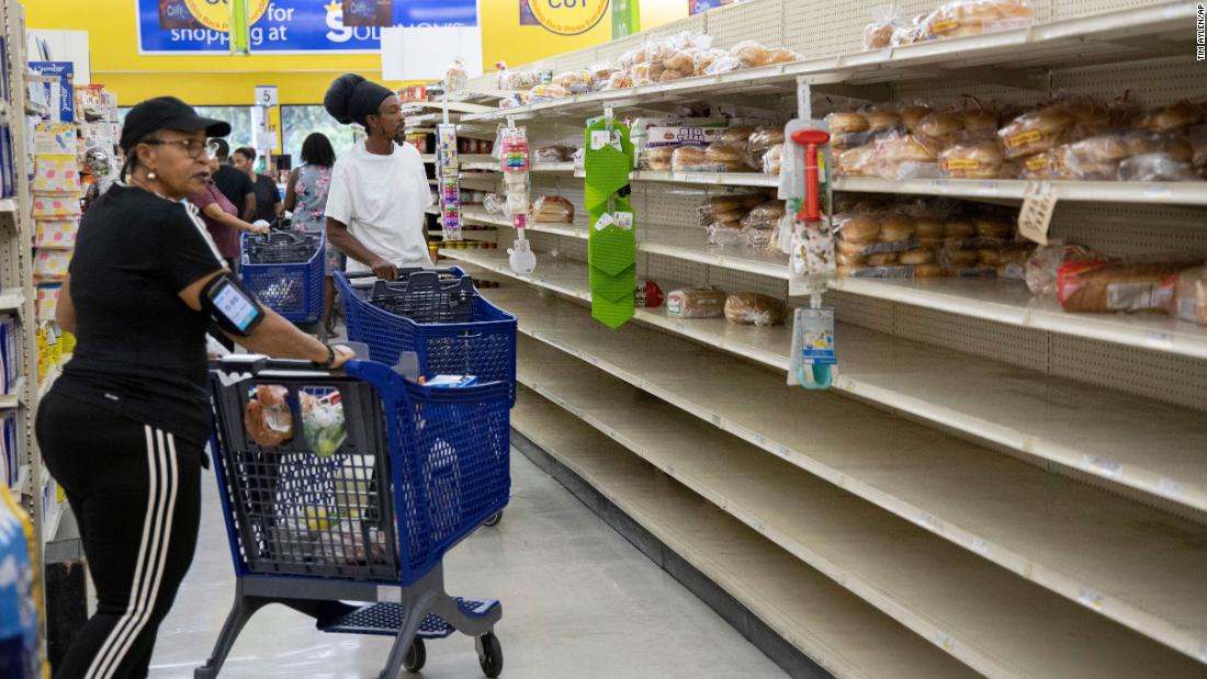 People shop for supplies before the arrival of Hurricane Dorian, in Freeport, Bahamas, Friday, Aug. 30. Tim Aylen/AP