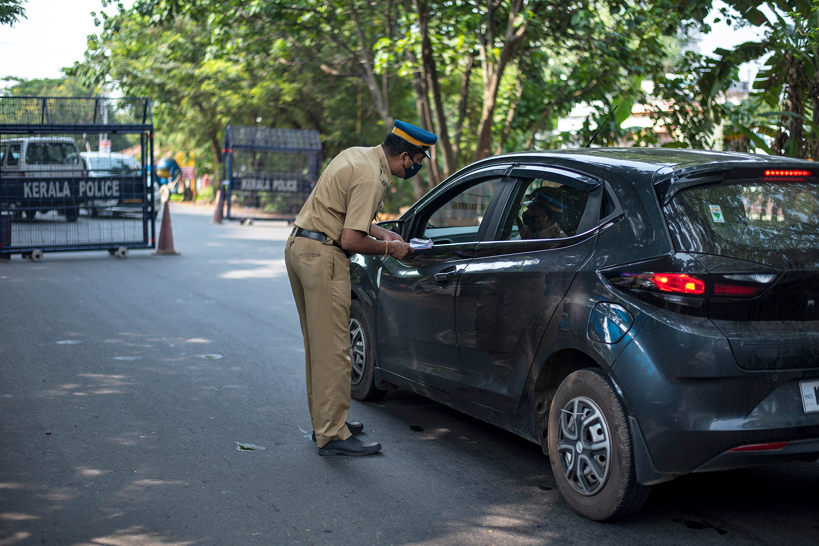 A policeman checks on commuters during weekend restrictions imposed to curb the spread of Covid-19 in Kochi, Kerala state, India, on April 25.