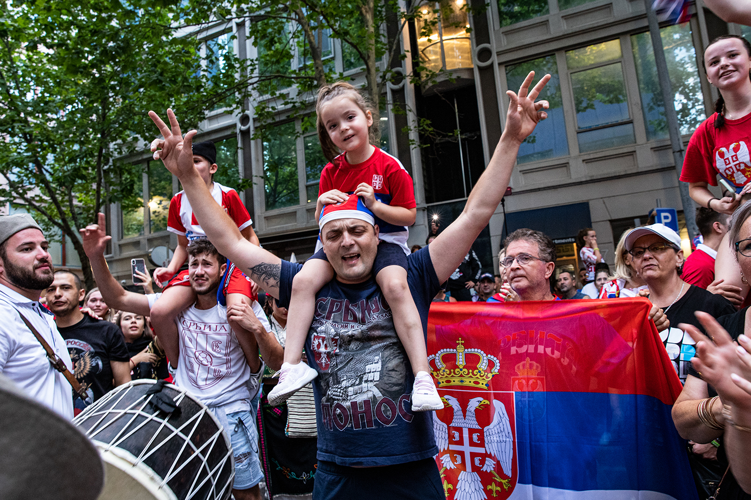 Serbian tennis fans celebrate at Collins Street as they wait for Djokovic to leave on January 10, 2022 in Melbourne, Australia. 
