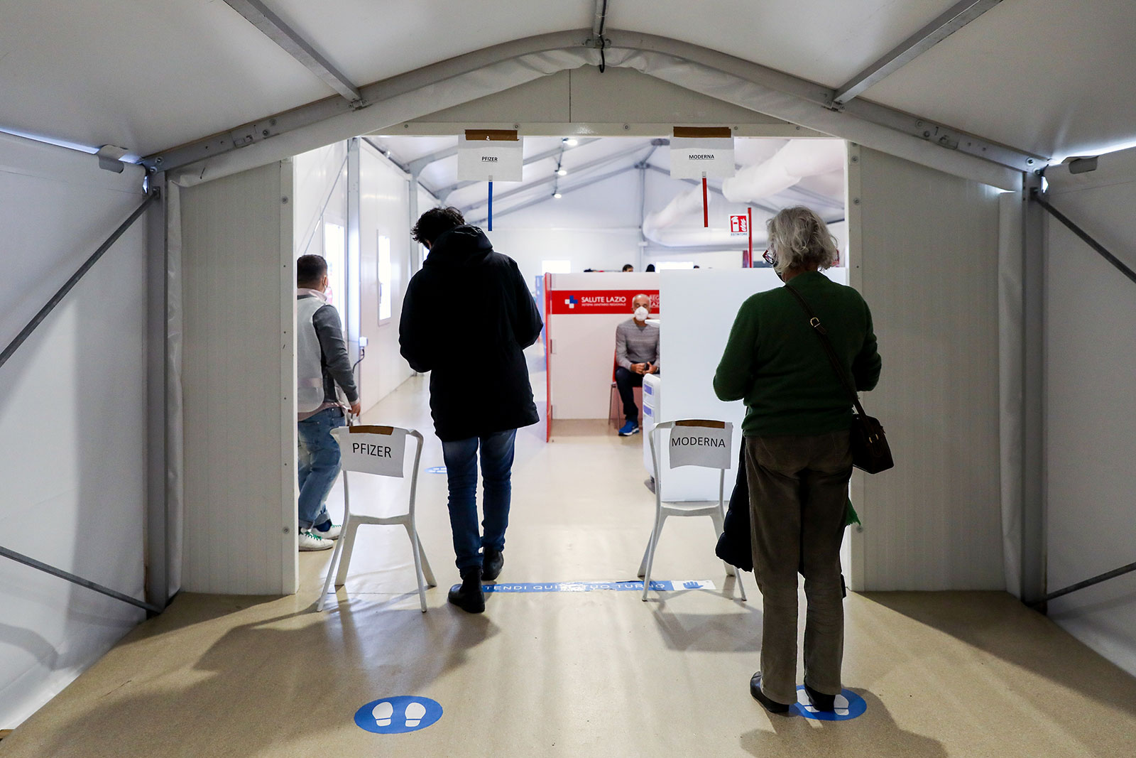 People wait in line at a Covid-19 vaccination center at a train station in Rome, Italy, on December 3.