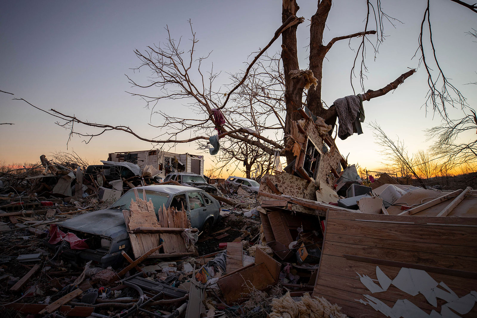 A car sits among debris from a destroyed home in Dawson Springs, Kentucky, on December 12.