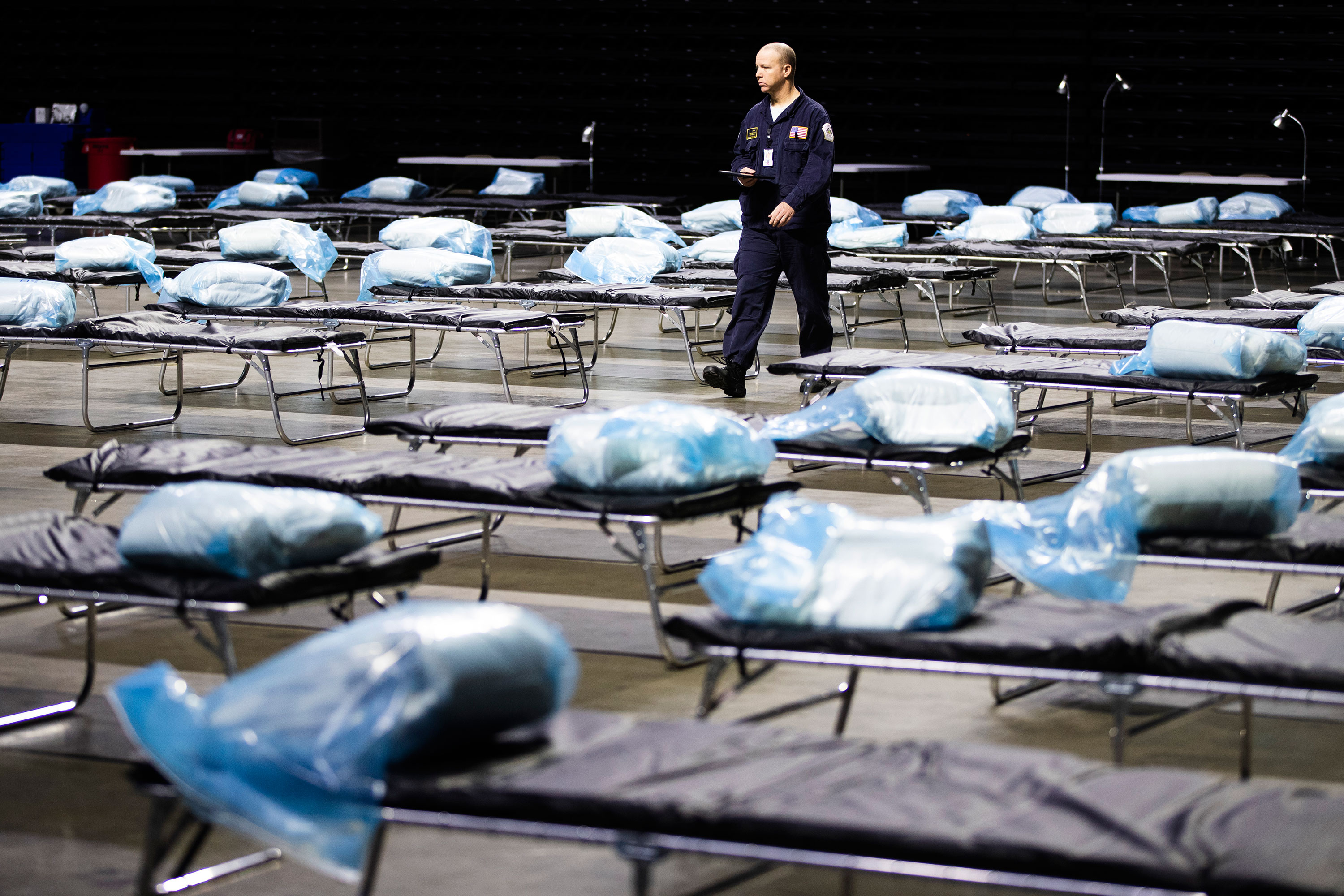 A Pennsylvania Task Force 1 member walks amongst the beds of a temporary hospital for coronavirus patients set up at Temple University in Philadelphia on March 30.