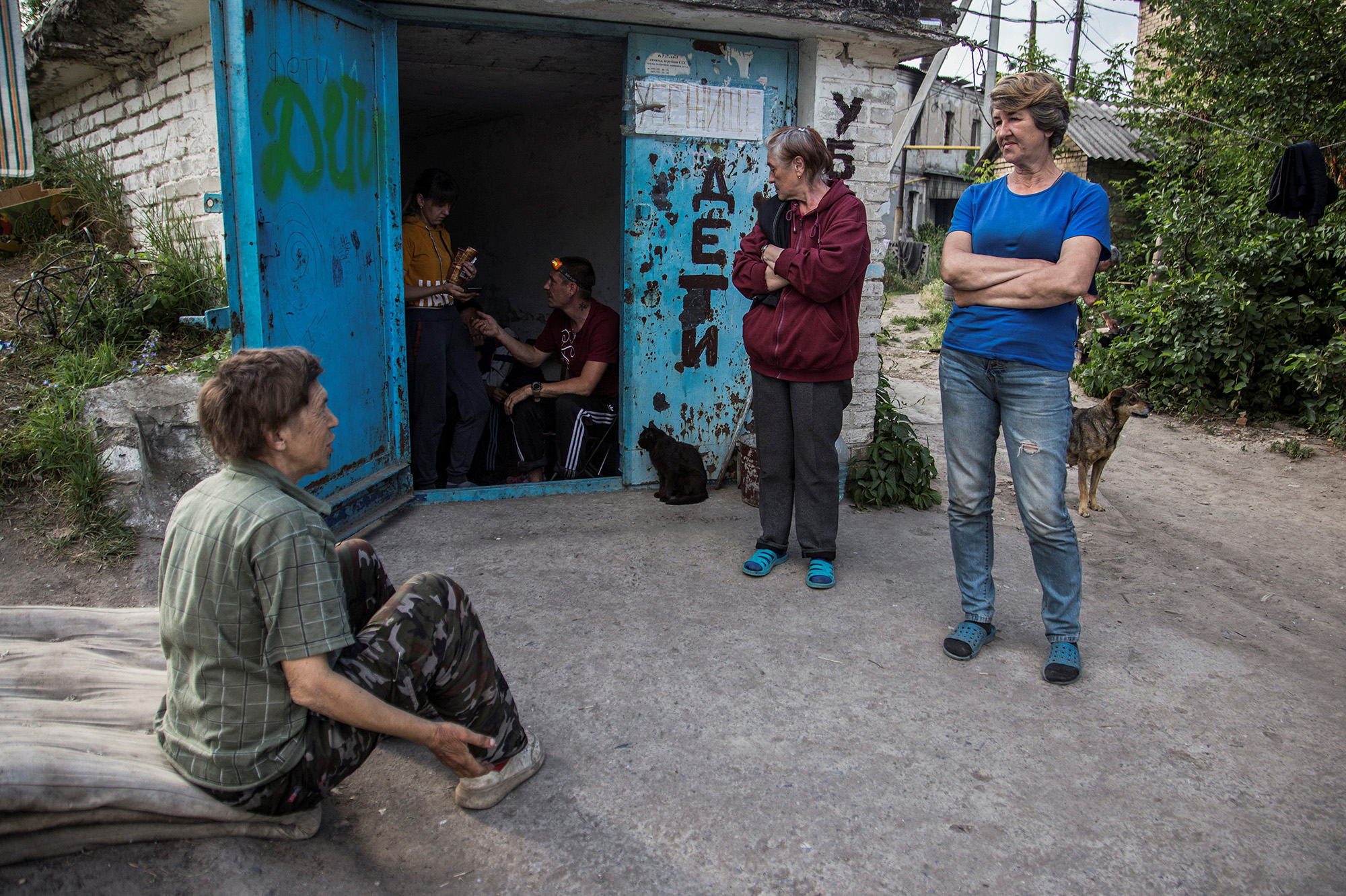 Local residents gather near a shelter during a military strike in Lysychansk, Ukraine, on June 17.