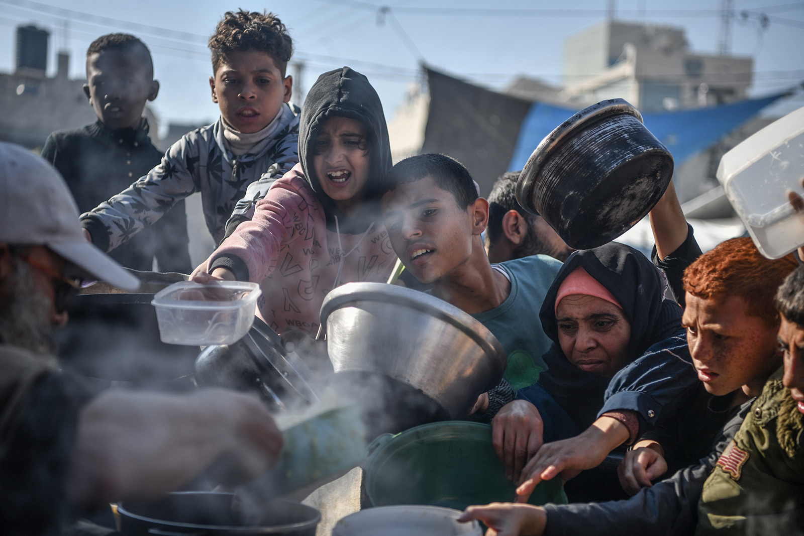 Palestinians receive food and humanitarian aid in Rafah, Gaza on December 19.