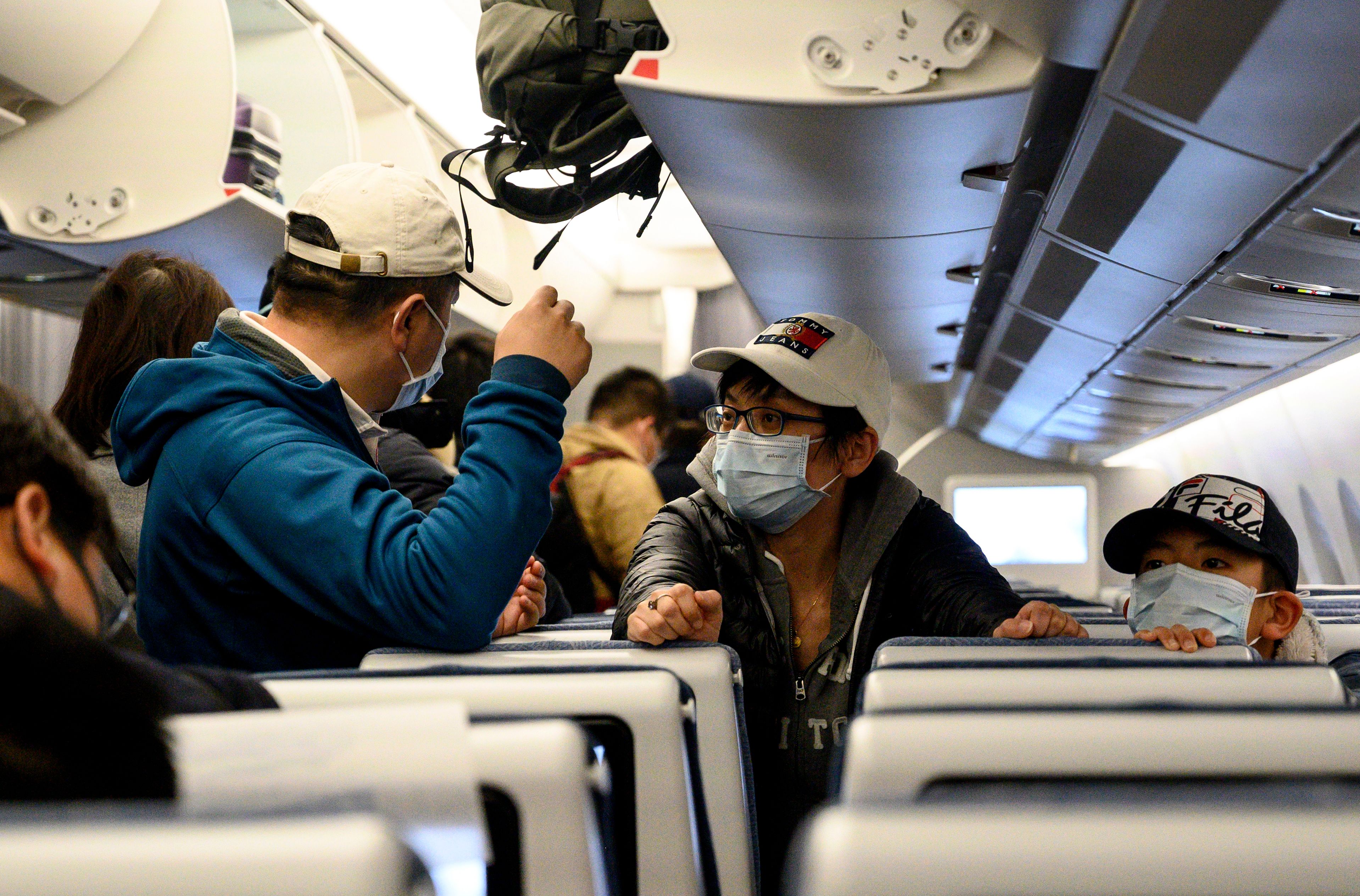 Passengers on a plane at the Shanghai Pudong International Airport on February 4, 2020.