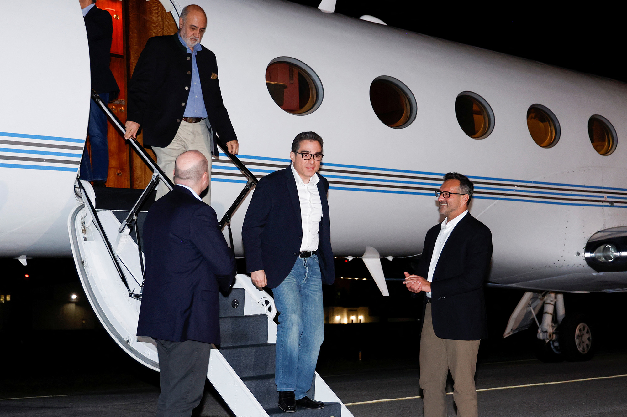 U.S. Special Presidential Envoy for Hostage Affairs Roger Carstens, right, greets freed Americans Siamak Namazi, Morad Tahbaz and Emad Shargi, who were released in a prisoner swap deal between U.S and Iran, as they arrive at Davison Army Airfield at Fort Belvoir, Virginia, U.S., on September 19, 2023.