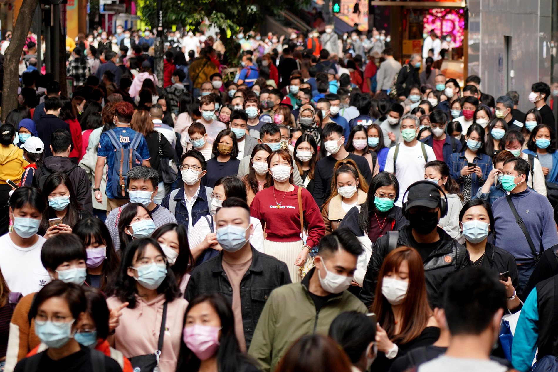 People wearing masks visit Causeway Bay on the third day of the Chinese New Year, on February 14, 2021, in Hong Kong. 