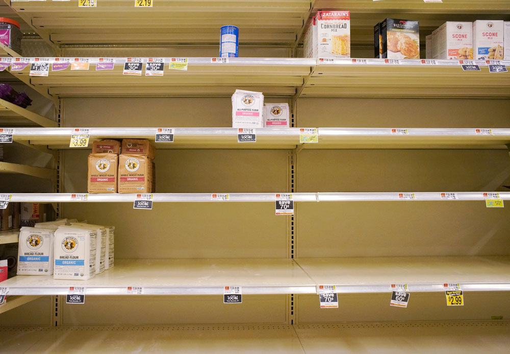 Shelves in the flour section are largely empty save for a few organic options at the Hannaford supermarket in Scarborough on Friday, March 27.