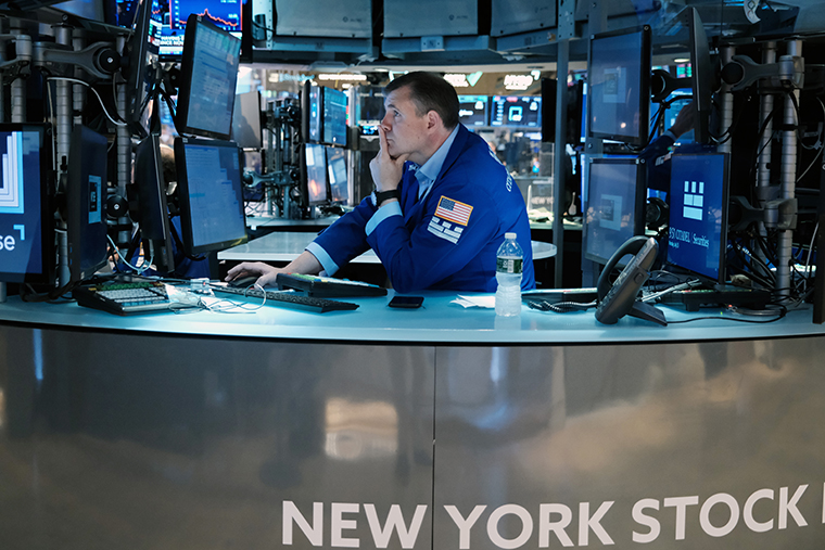A traders works on the floor of the New York Stock Exchange on July 25 in New York City.