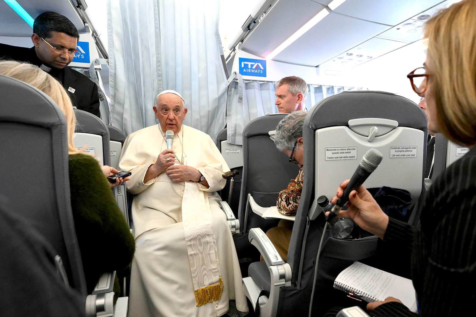 Pope Francis speaks to journalists traveling with him on the return flight to Rome from his Apostolic Journey to Hungary in Budapest on April 30.