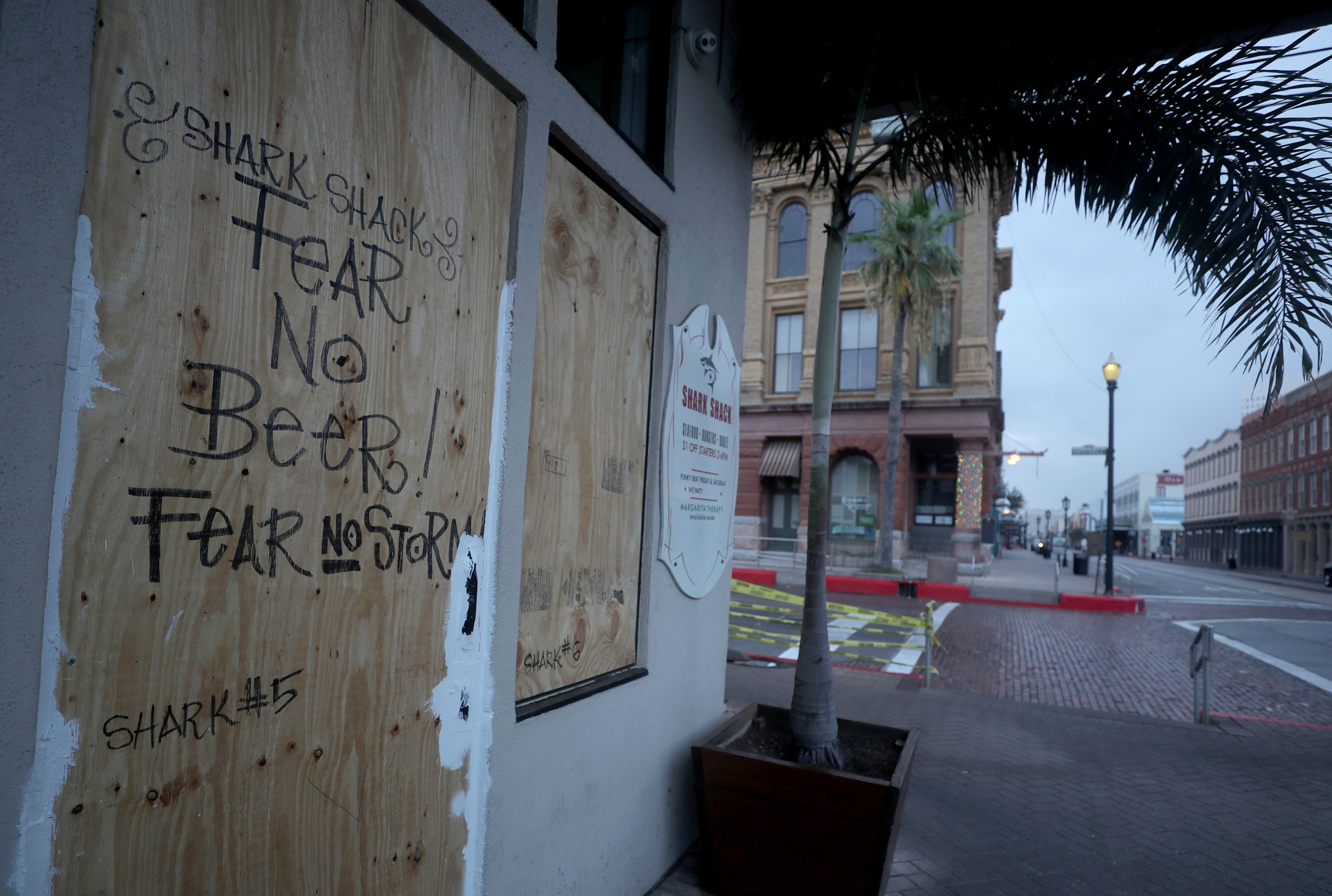 The Shark Shack Beach Bar and Grill is boarded up on the nearly deserted Strand Street in Galveston, Texas, on Wednesday, August 26.