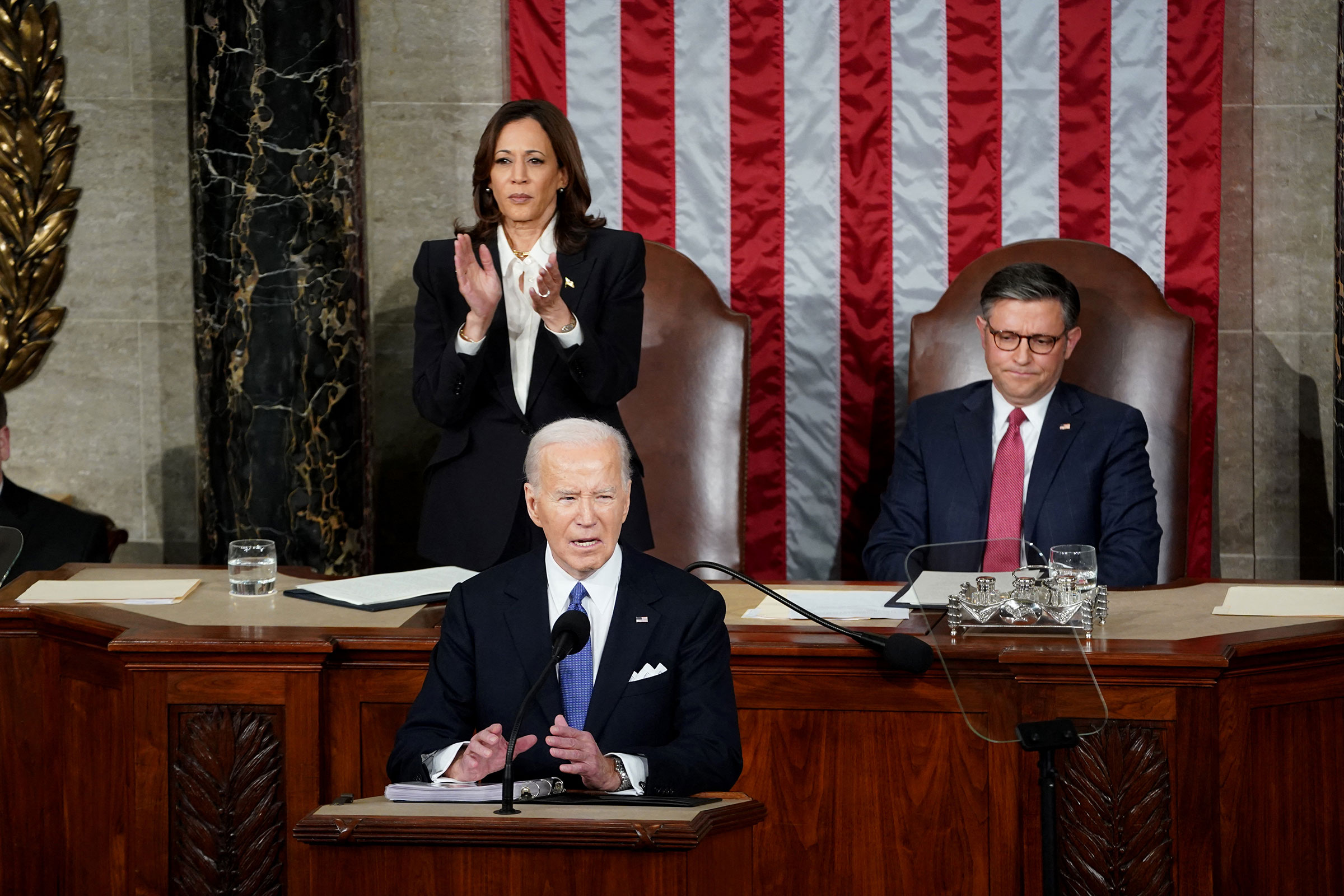 Vice President Kamala Harris applauds as House Speaker Mike Johnson looks on as President Joe Biden delivers the State of the Union address.