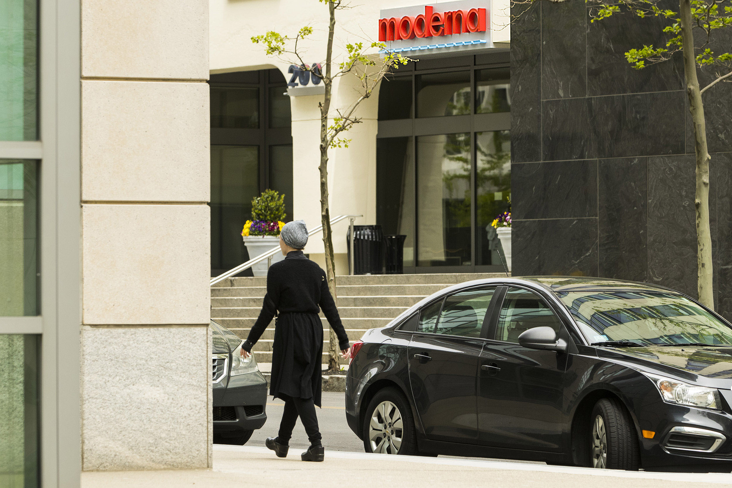 A pedestrian walks past Moderna Inc. headquarters in Cambridge, Massachusetts, on May 25, 2020. 