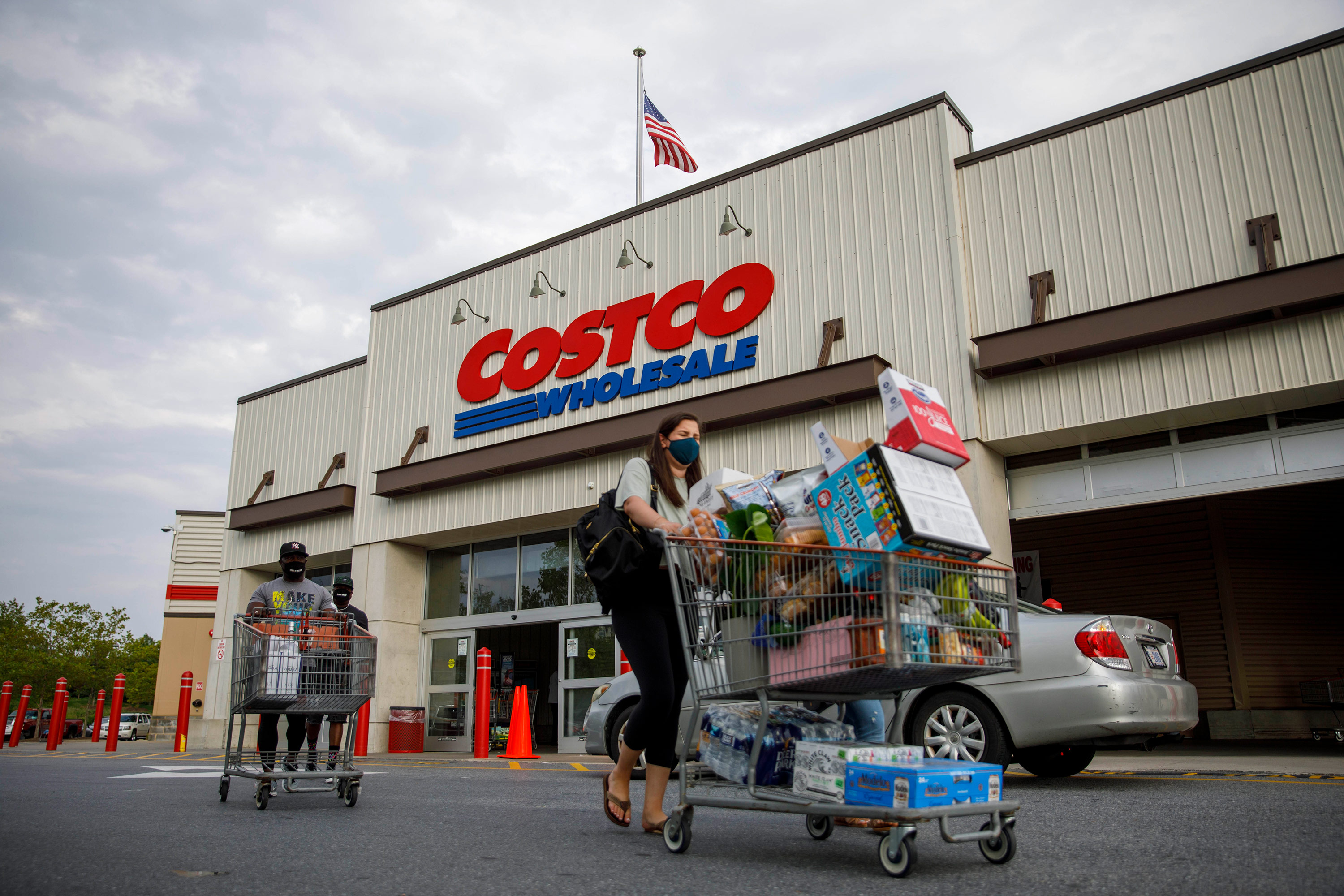 Shoppers leave a Costco store in Washington, DC, on August 14, 2020. 