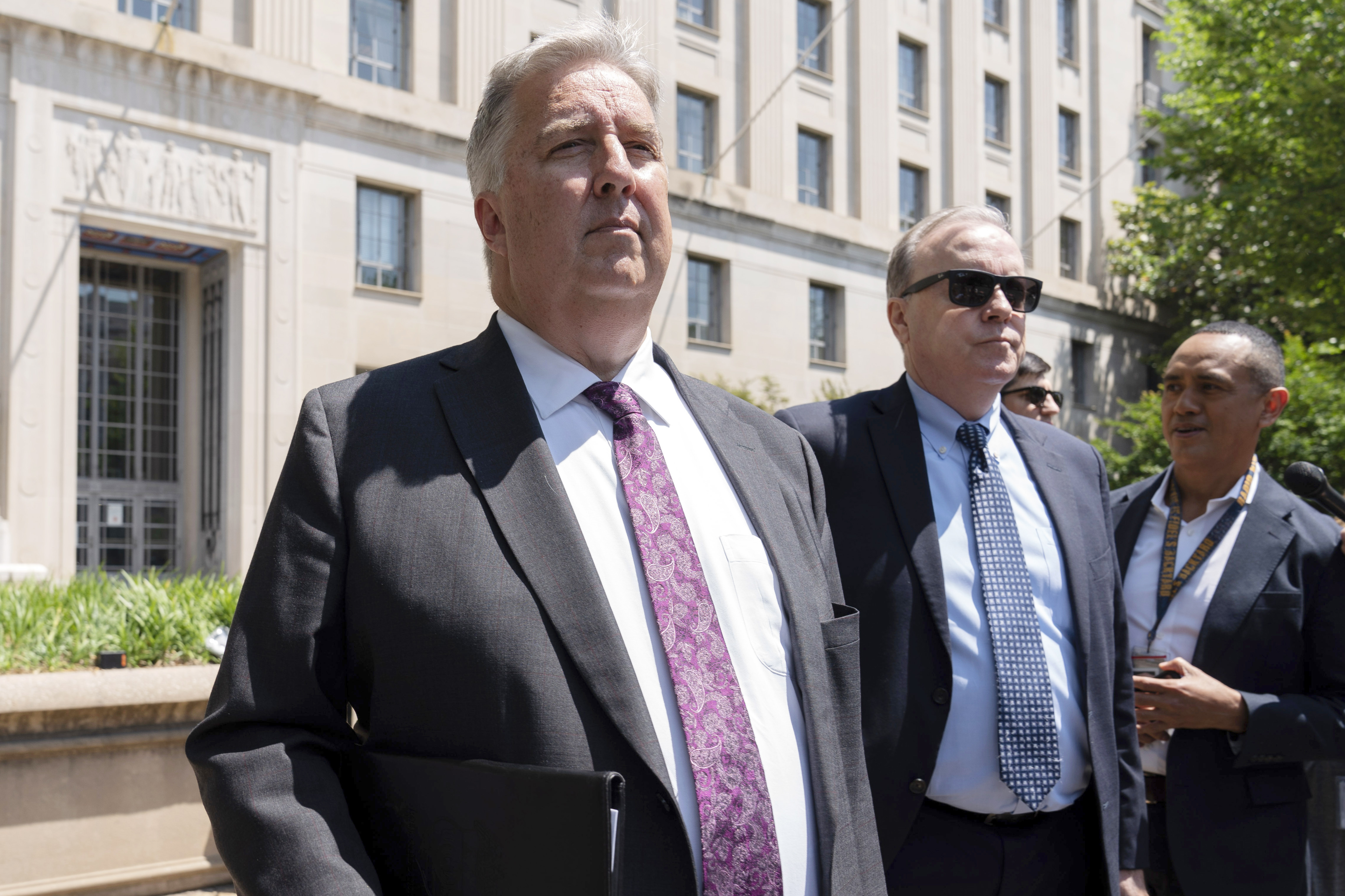 President Donald Trump's lawyers, James Trusty, left, and John Rowley, center, leave the Department of Justice on June 5, 2023, in Washington, D.C.