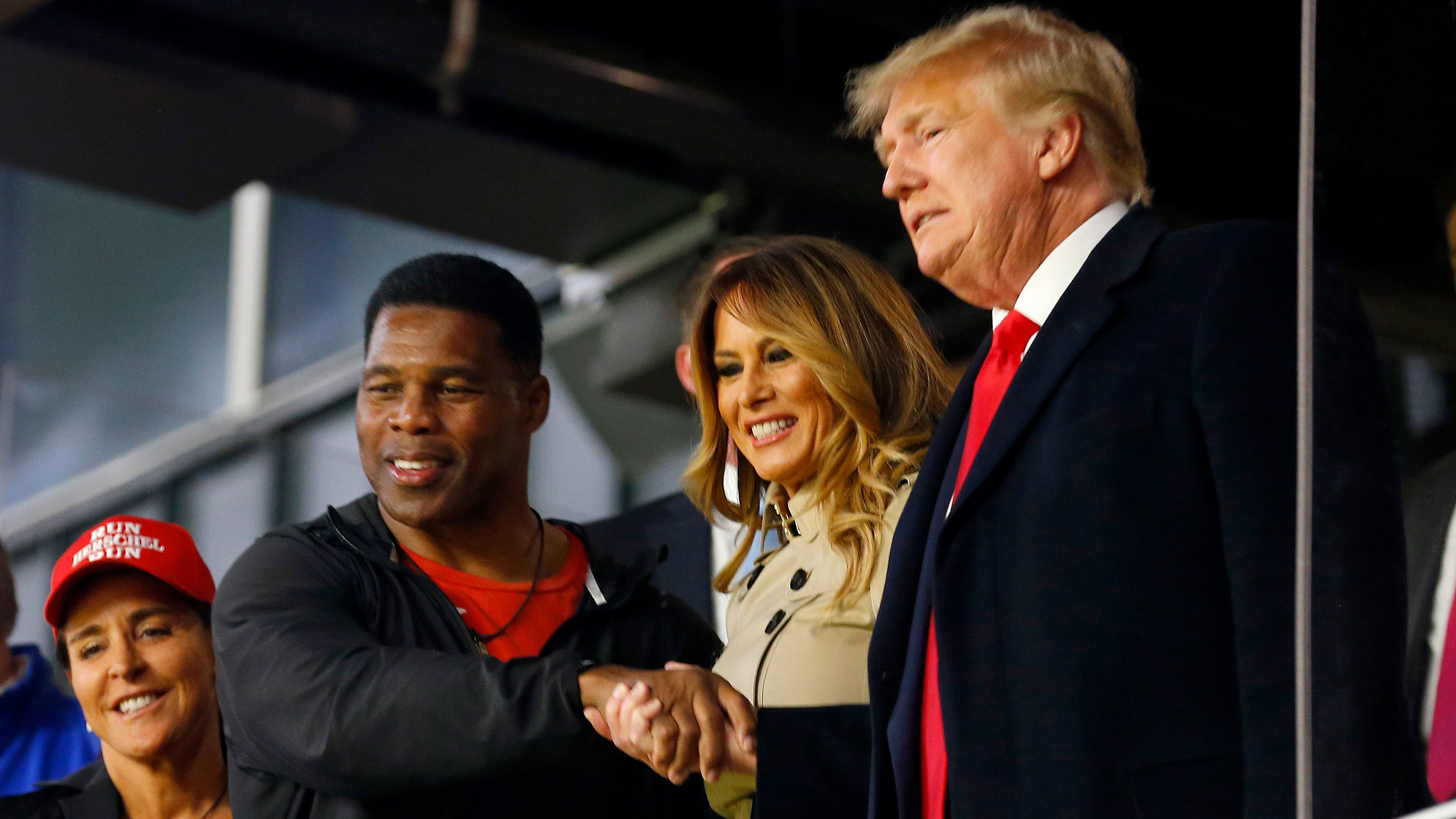 Herschel Walker shakes hands with former President Donald Trump before a World Series game in Atlanta last year.