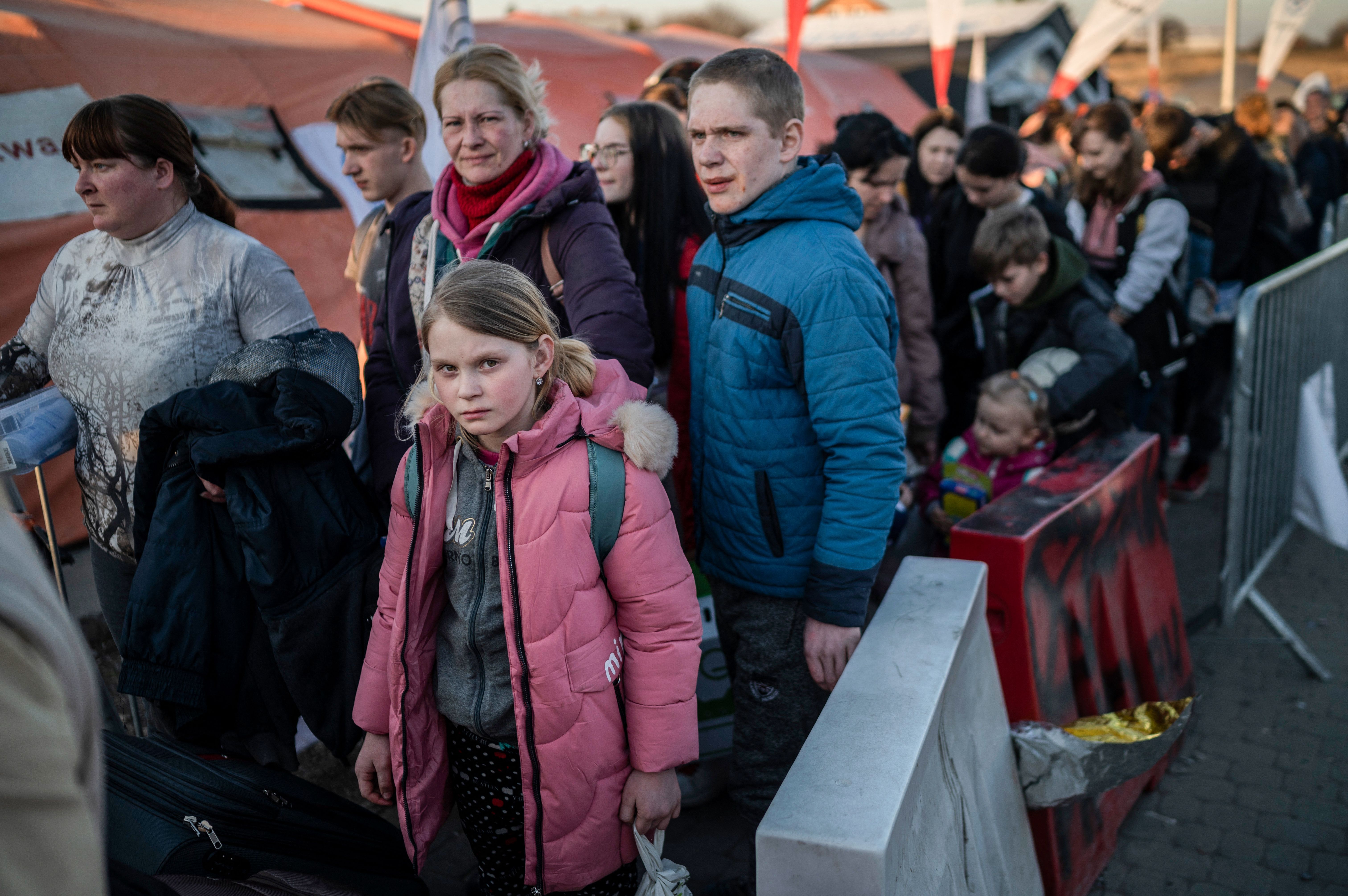 Refugees from Ukraine line up as they wait for further transport at the Medyka border crossing in southeastern Poland, on March 23.