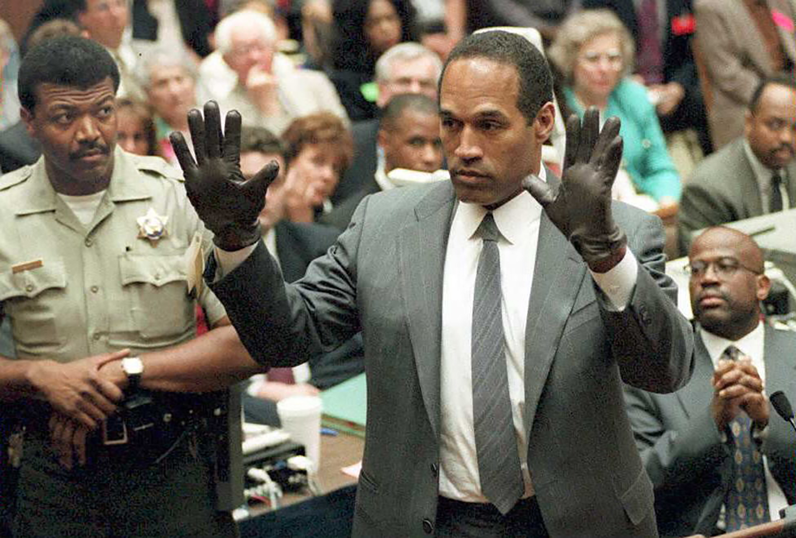 O.J. Simpson shows the jury a new pair of Aris extra-large gloves during his double murder trial in Los Angeles in 1995.