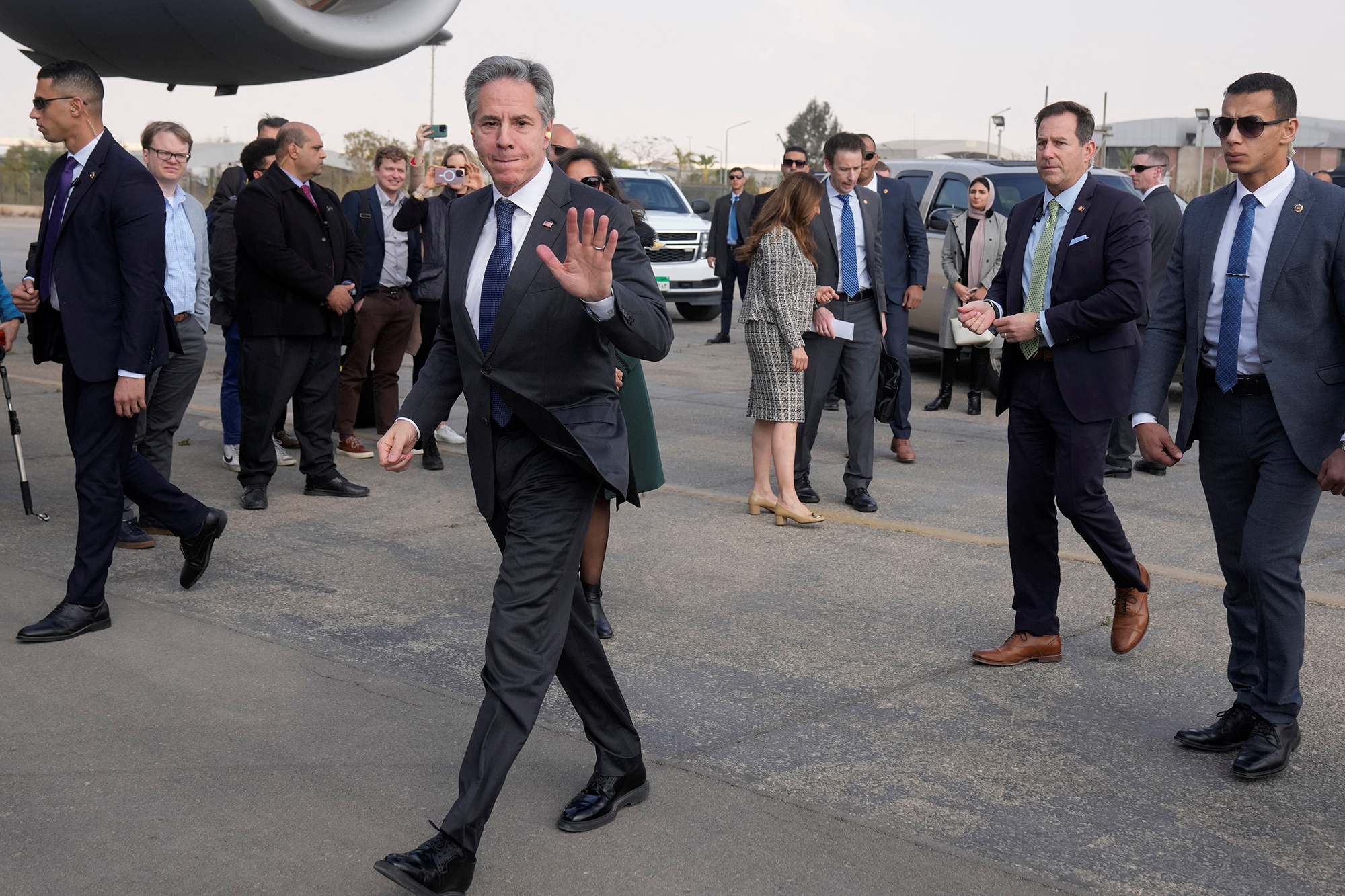 U.S. Secretary of State Antony Blinken waves as he departs for Doha, at Cairo East Airport, in Cairo, Egypt, on February 6.