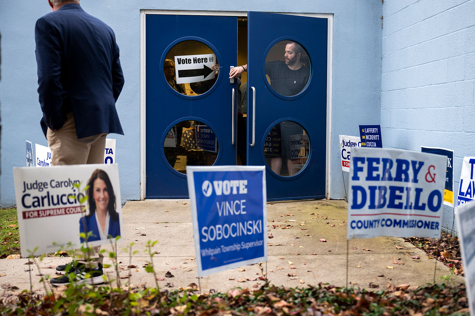 Election officials adjust a sign at the Wissahickon Valley Public Library in Blue Bell, Pennsylvania.