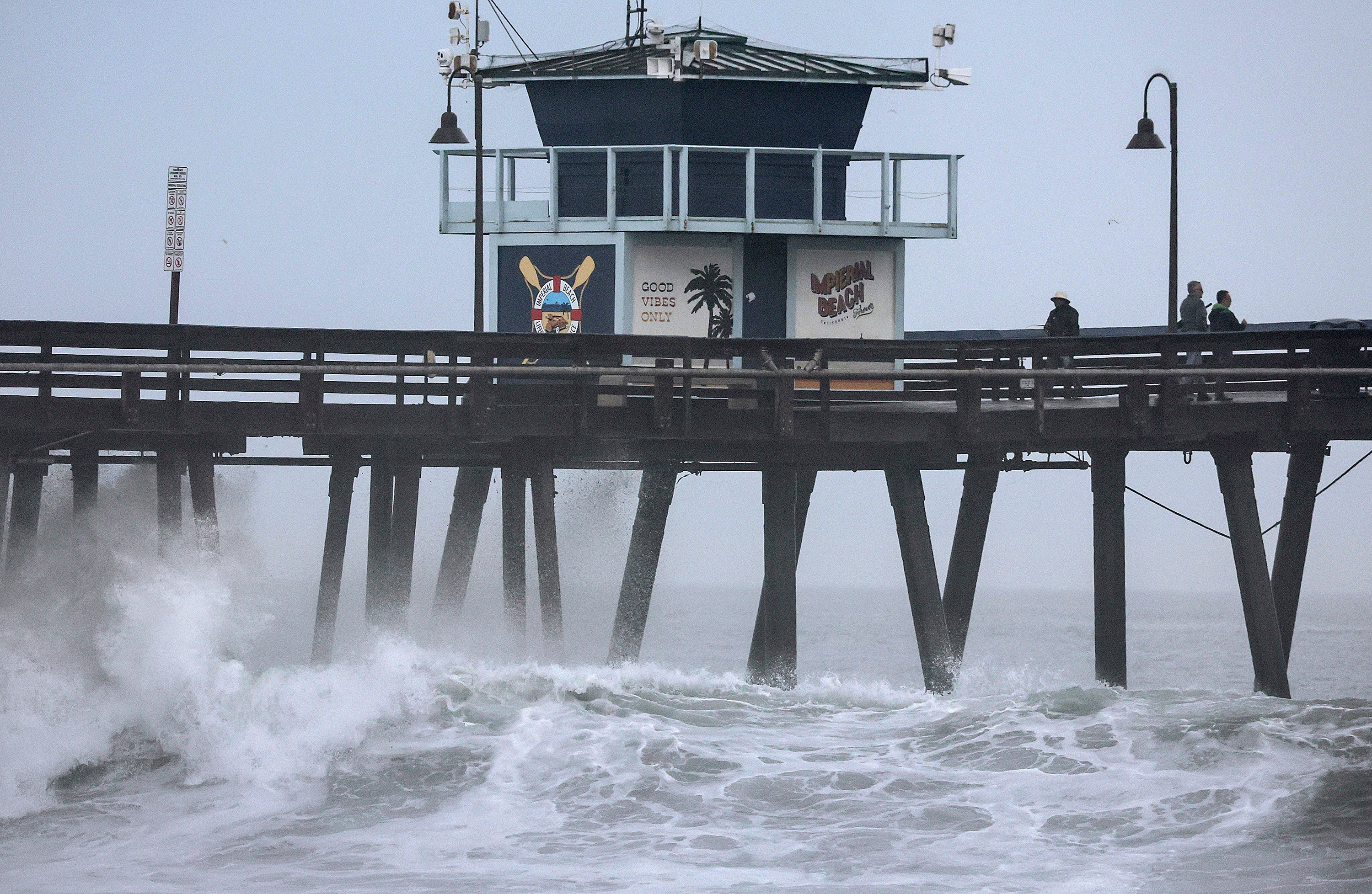 People stand on a pier in Imperial Beach, California, on August 20. 