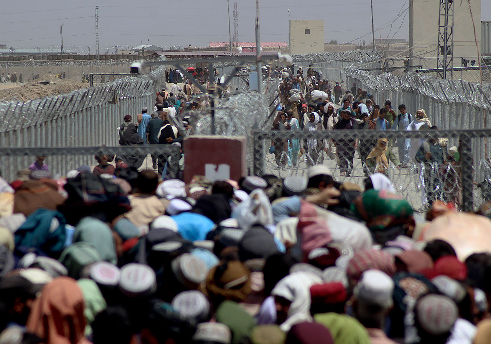 People cross the border between Pakistan and Afghanistan in Chaman, Pakistan, on Friday, August 13.